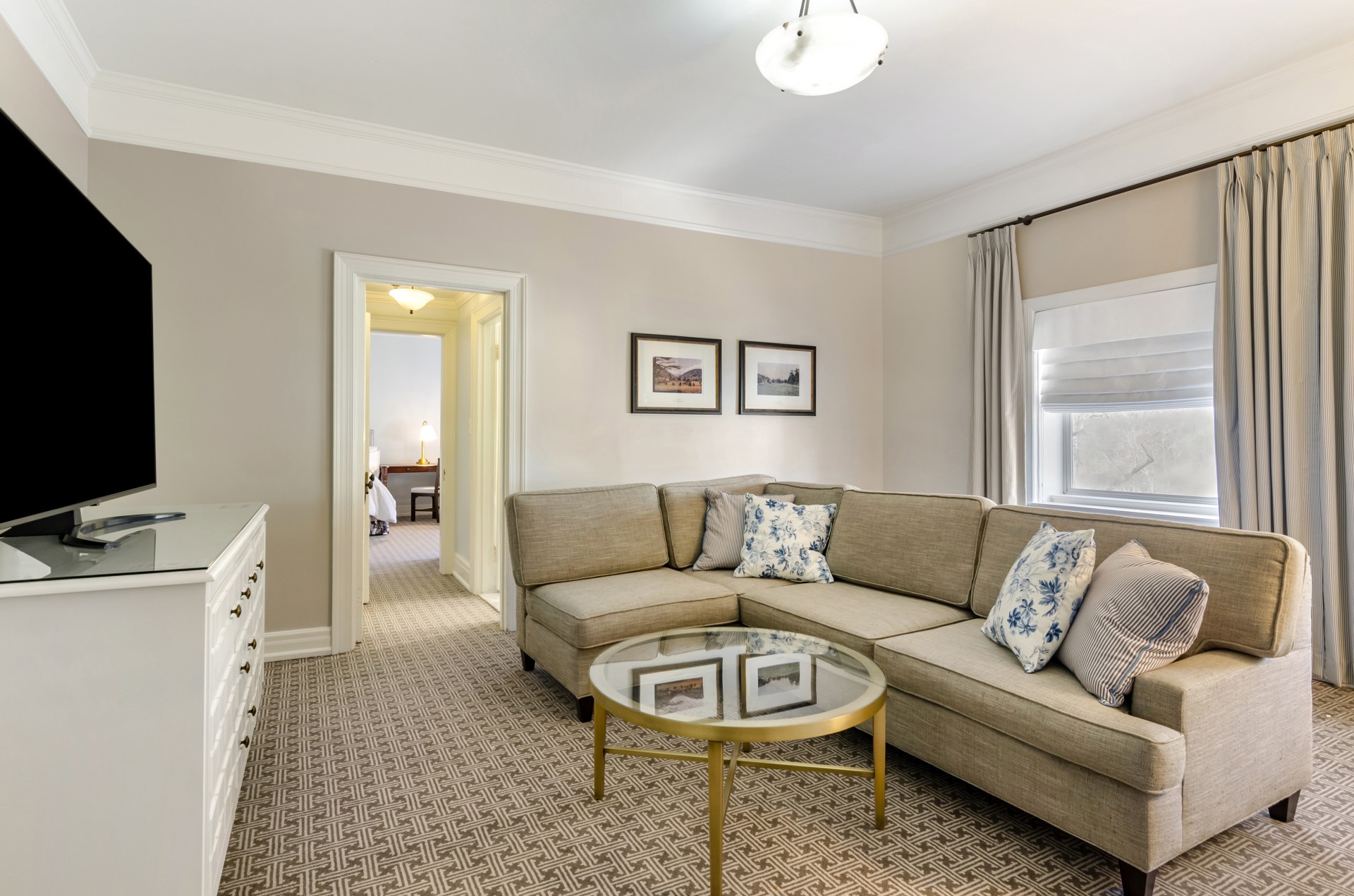 a living room with a couch and a glass coffee table