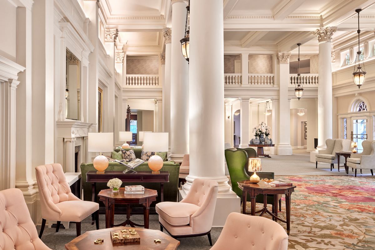 a room with a large white column and chairs