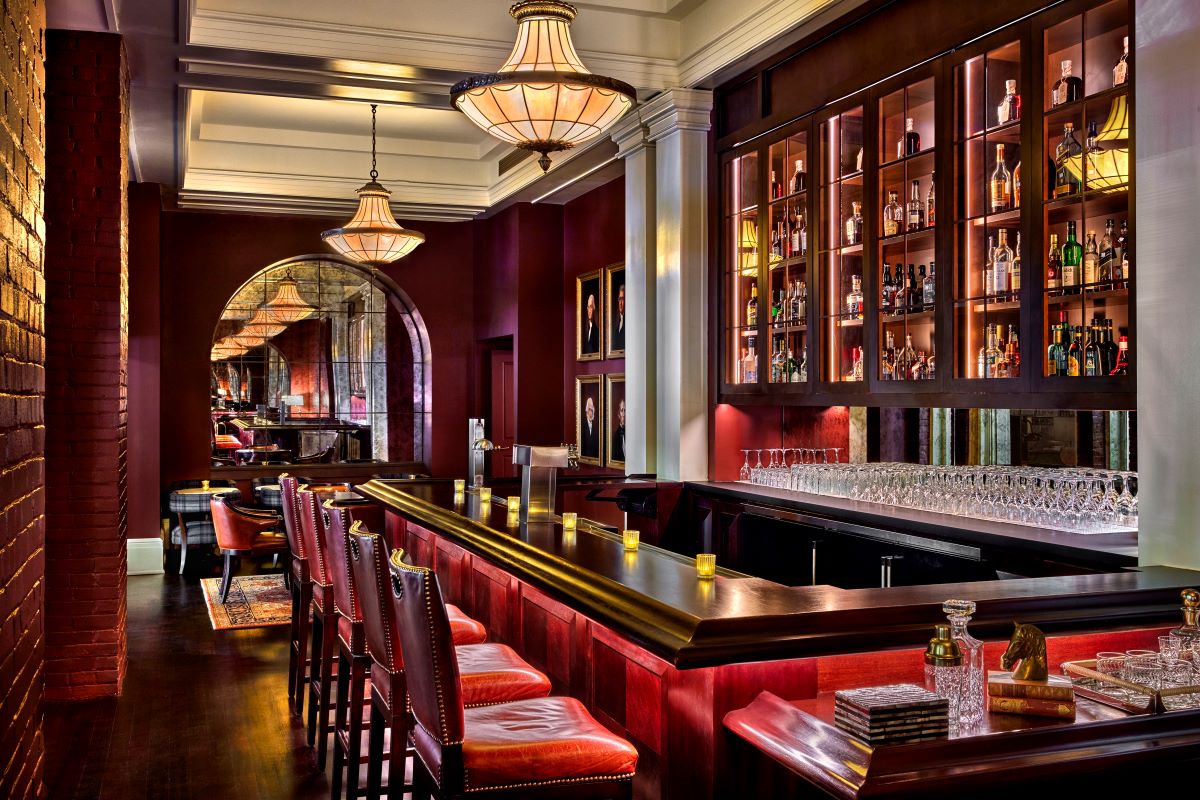 a bar with a row of wine glasses