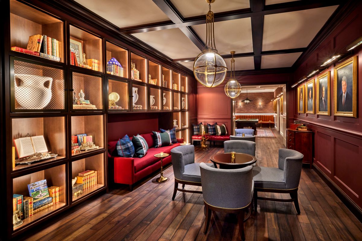 a room with a couch and chairs
