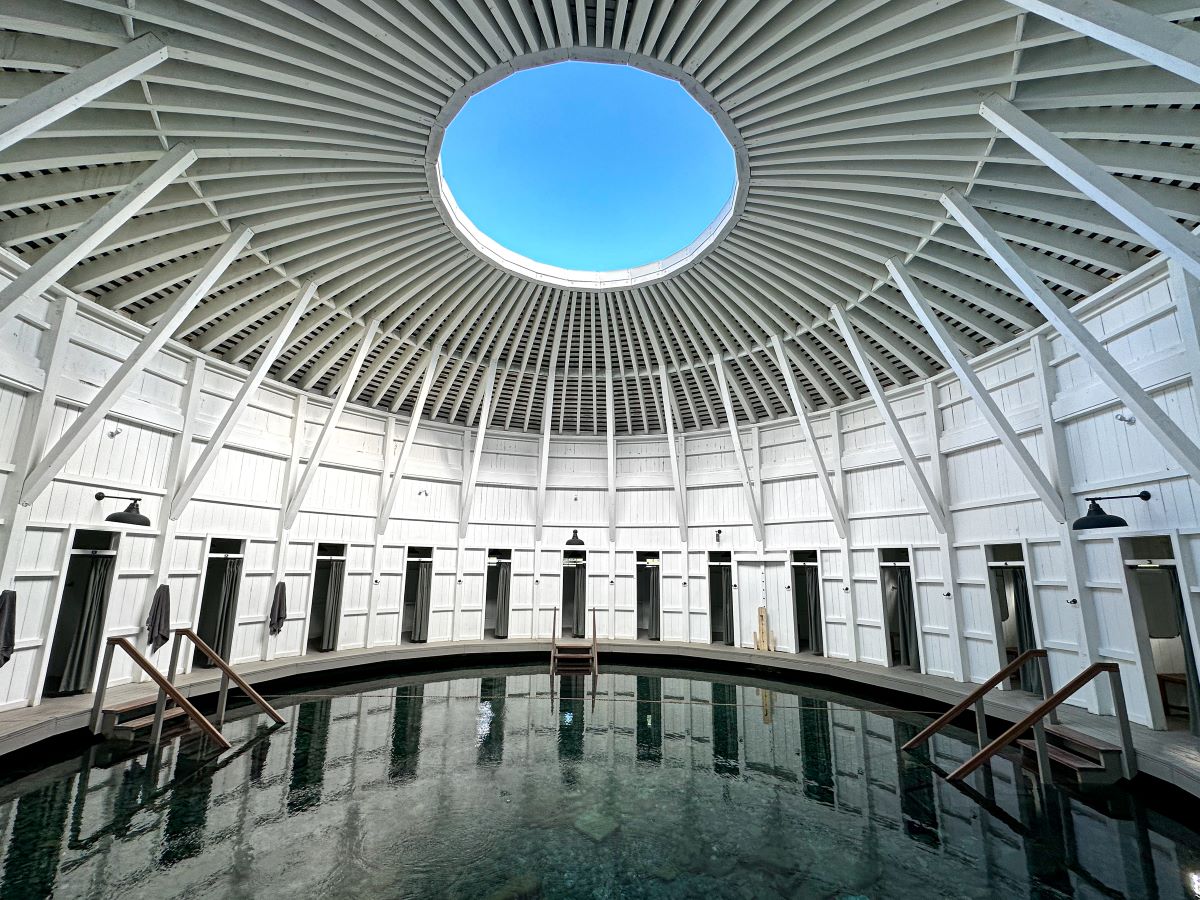 a circular building with a pool and a skylight
