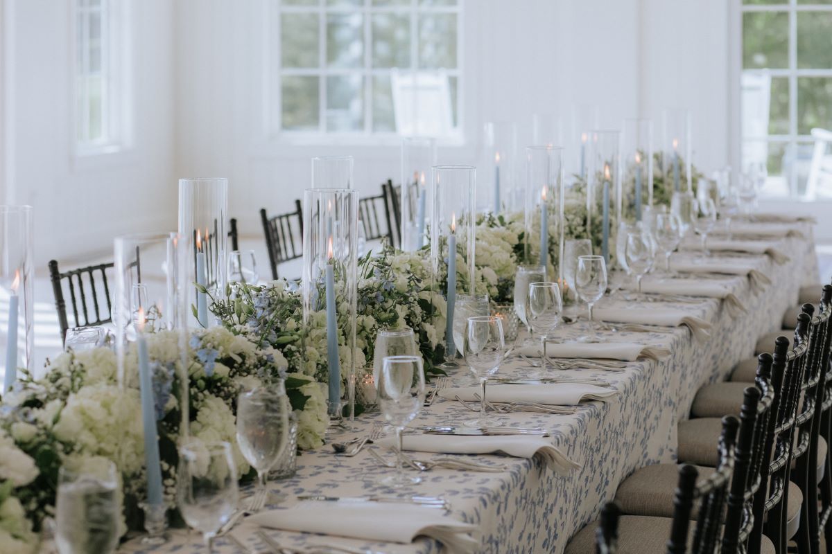 a long table with flowers and candles