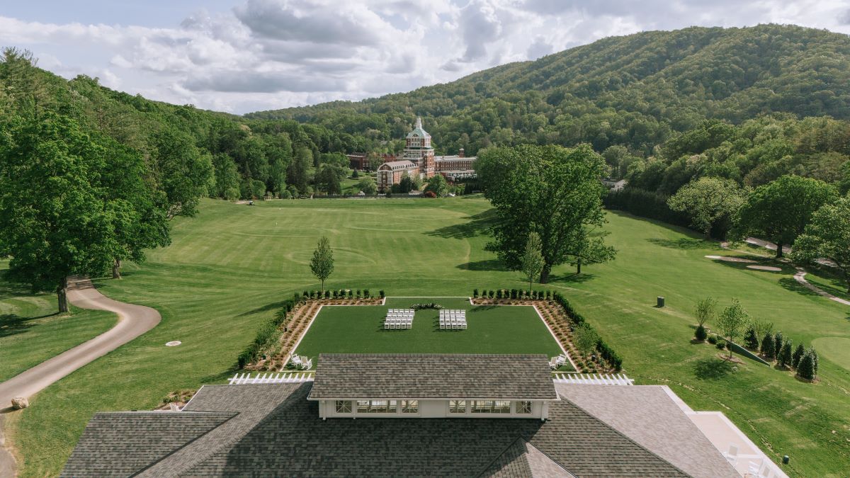 a large lawn with a large building in the background
