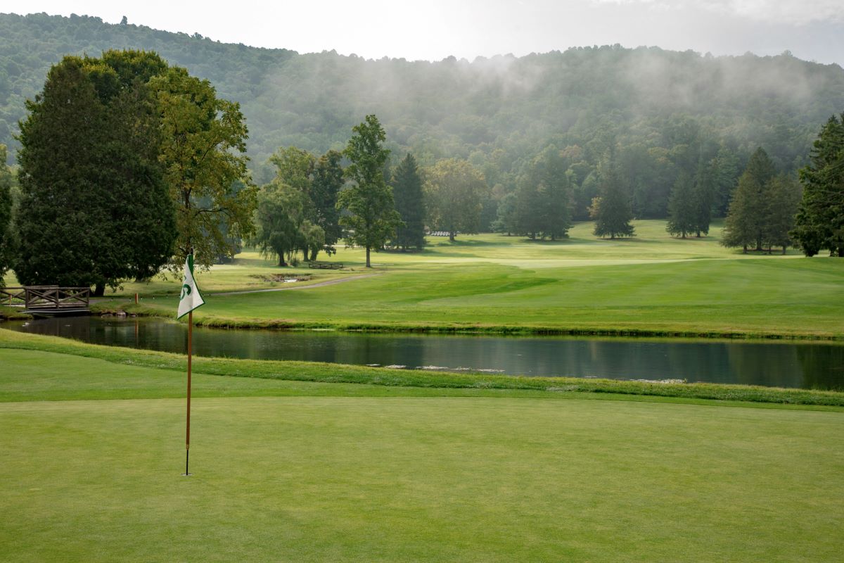 a golf course with a flag on the corner with Brantford Golf & Country Club in the background