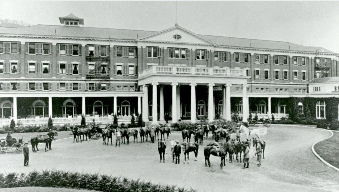 a group of horses outside a building