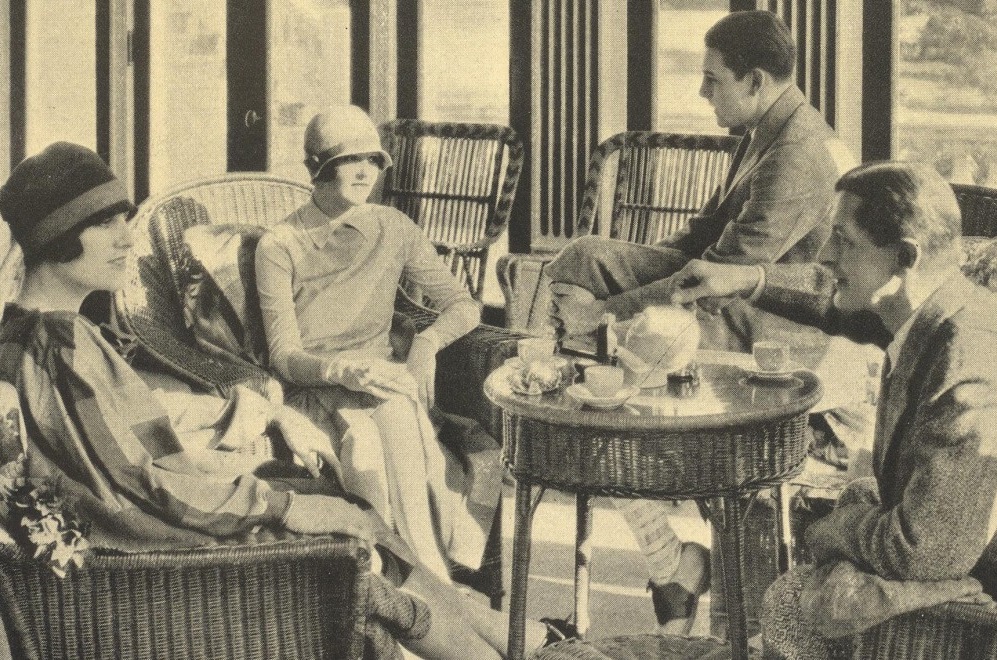 a group of people sitting in wicker chairs