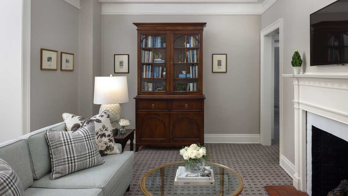 a living room with a glass cabinet and a couch