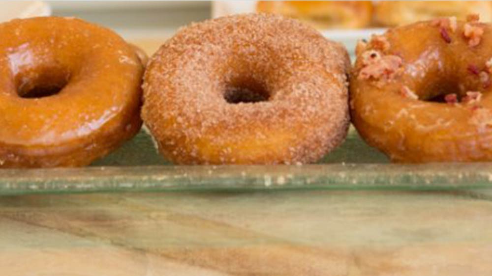 a group of donuts on a glass plate