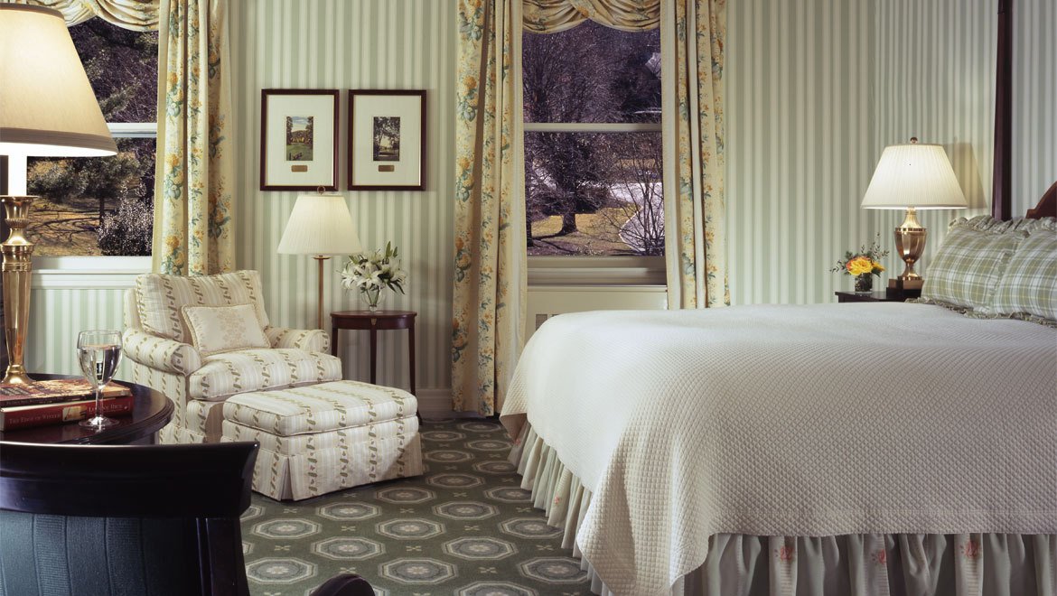 a bedroom with striped walls and a bed