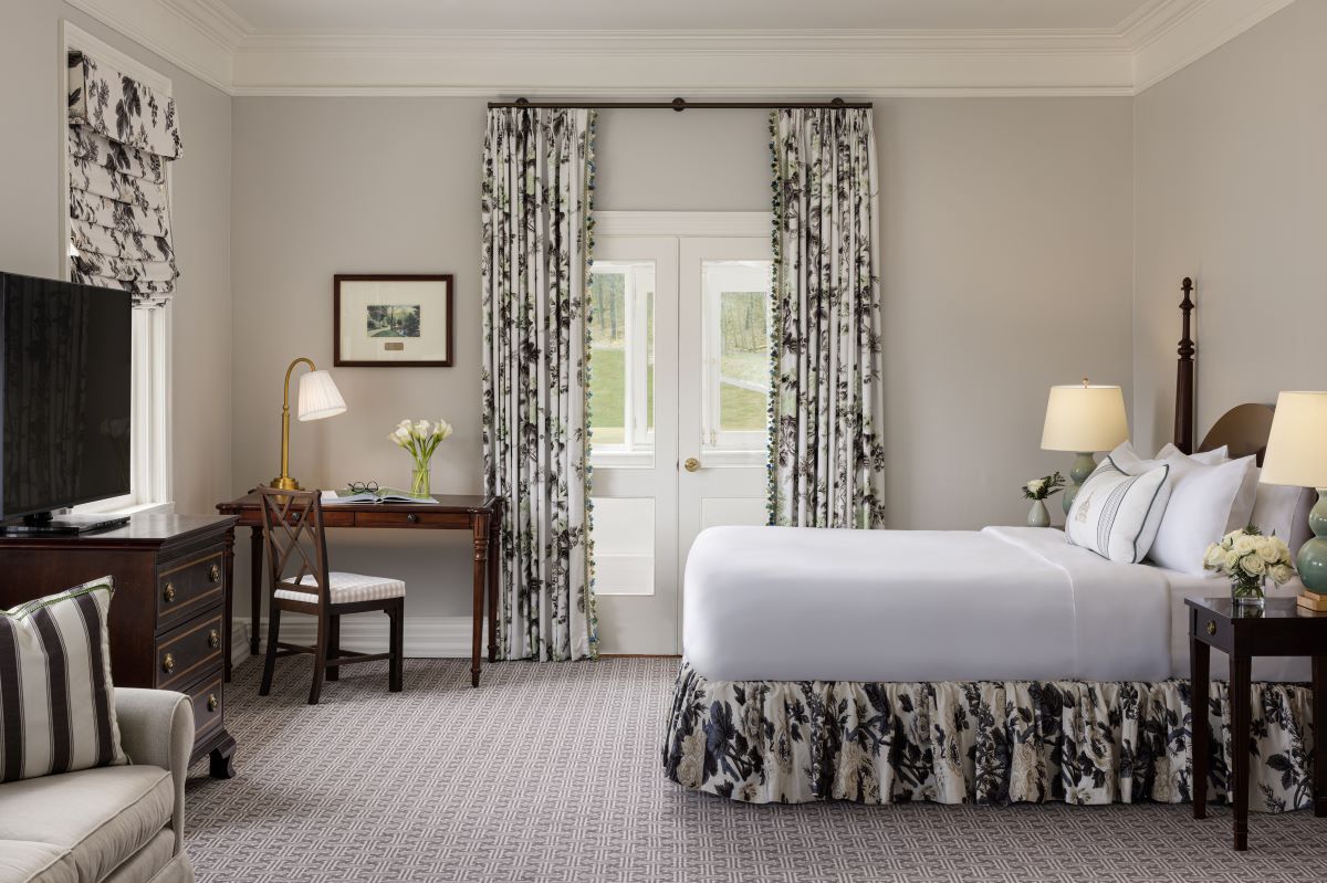 a bedroom with a desk and a bed
