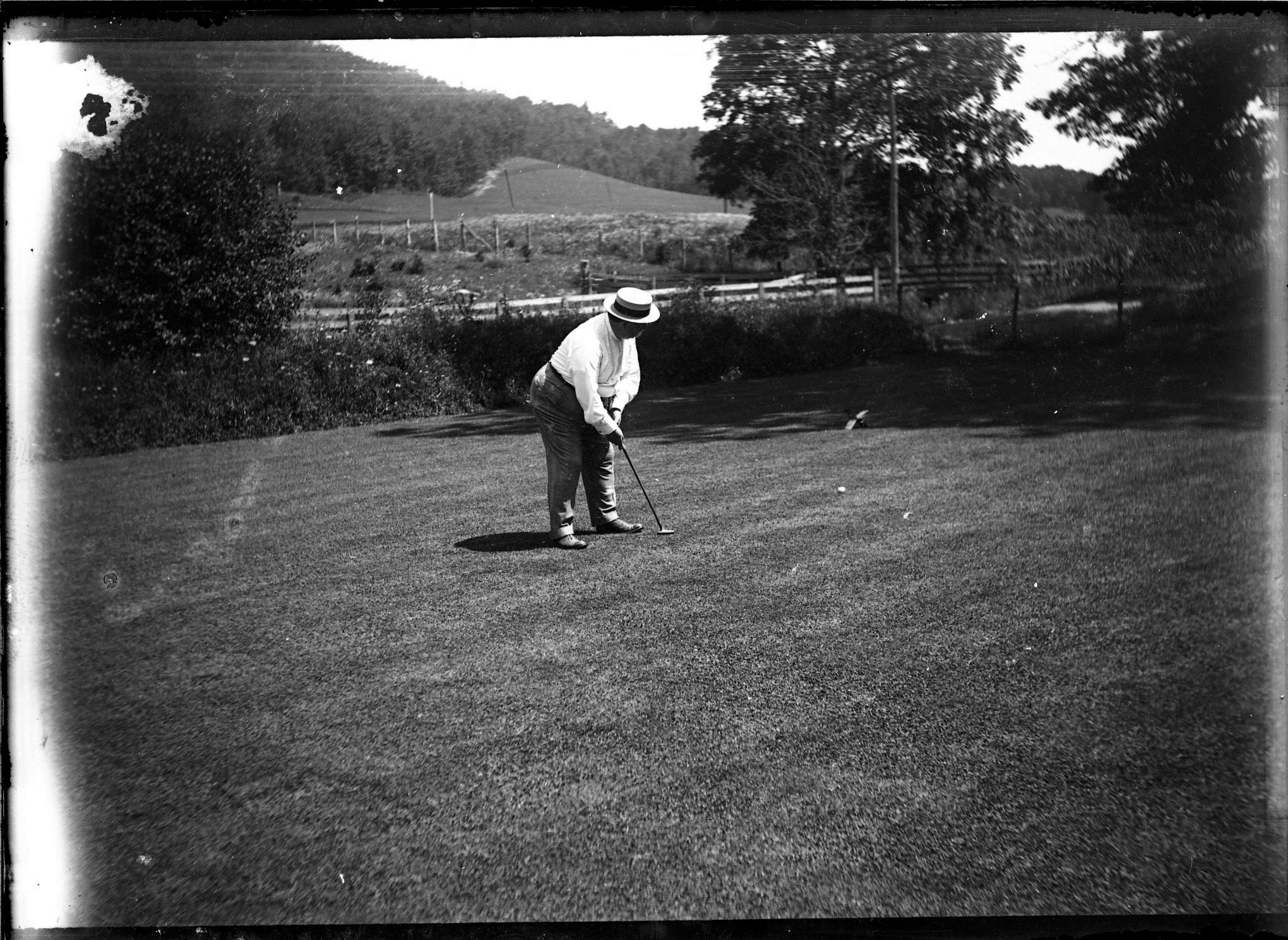 a man playing golf on a golf course