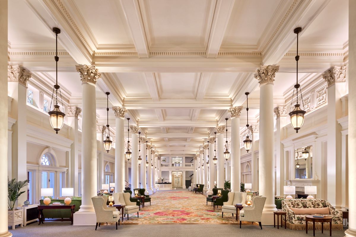 a large room with white columns and chairs