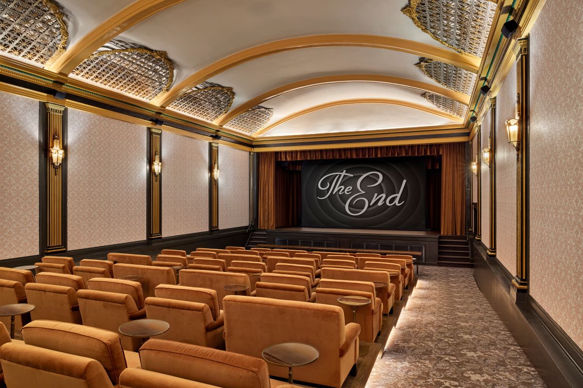 a movie theater with chairs and a screen