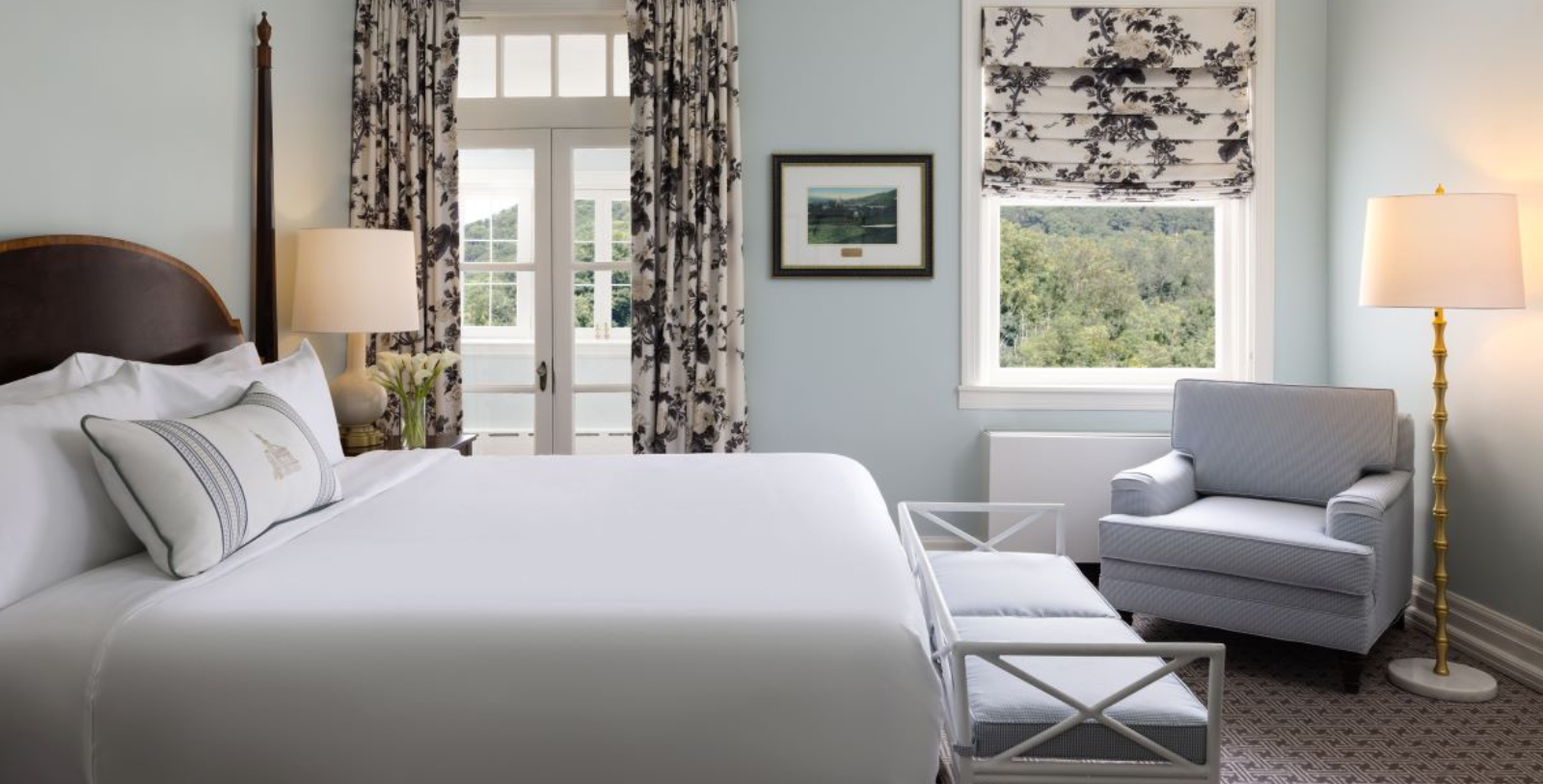 a bedroom with a bed and chairs