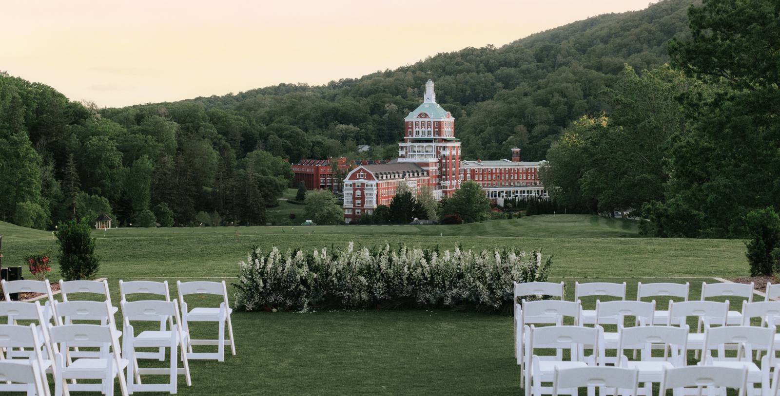 a lawn with chairs and The Homestead in the background