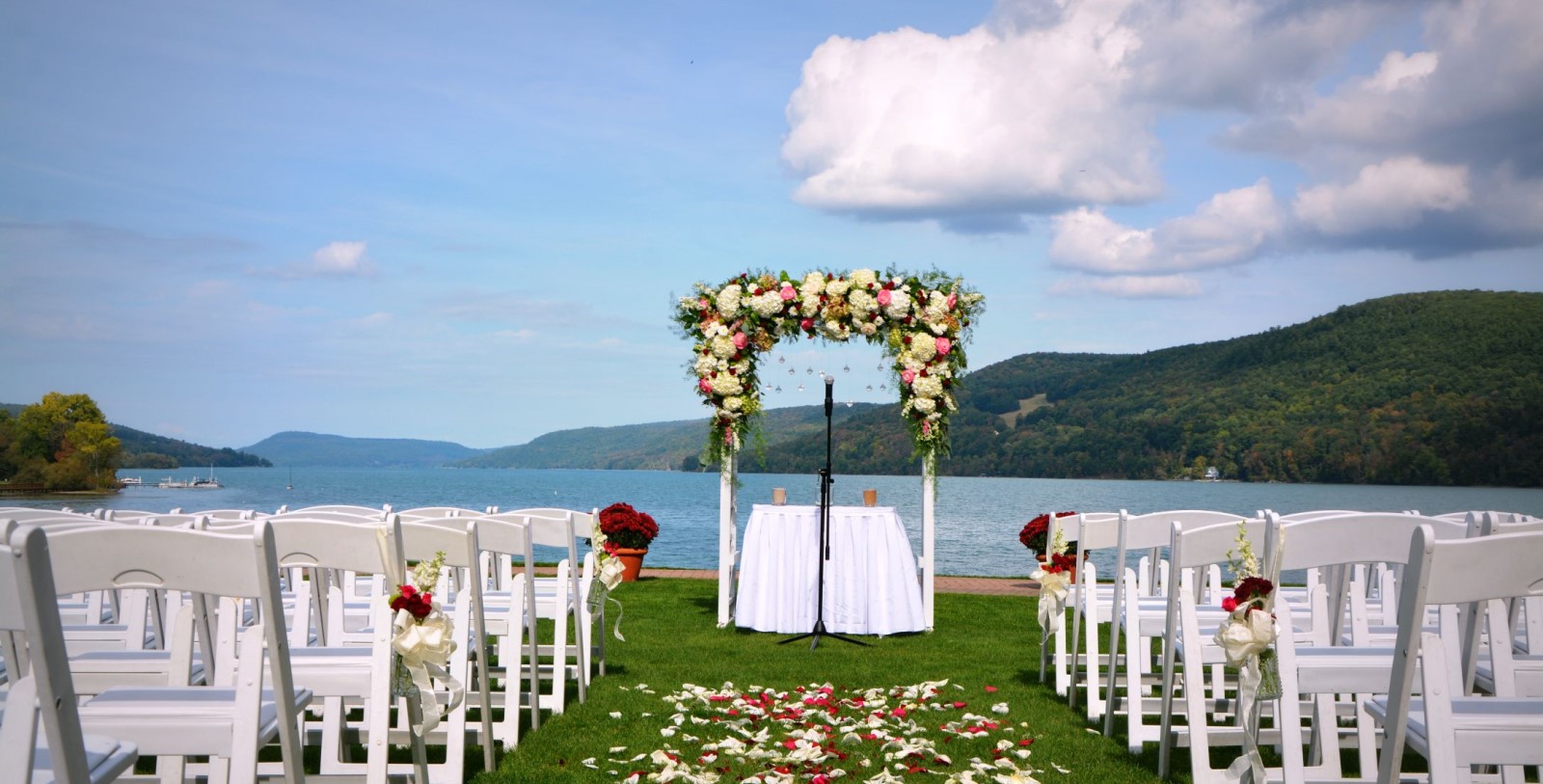 a wedding set up with chairs and flowers