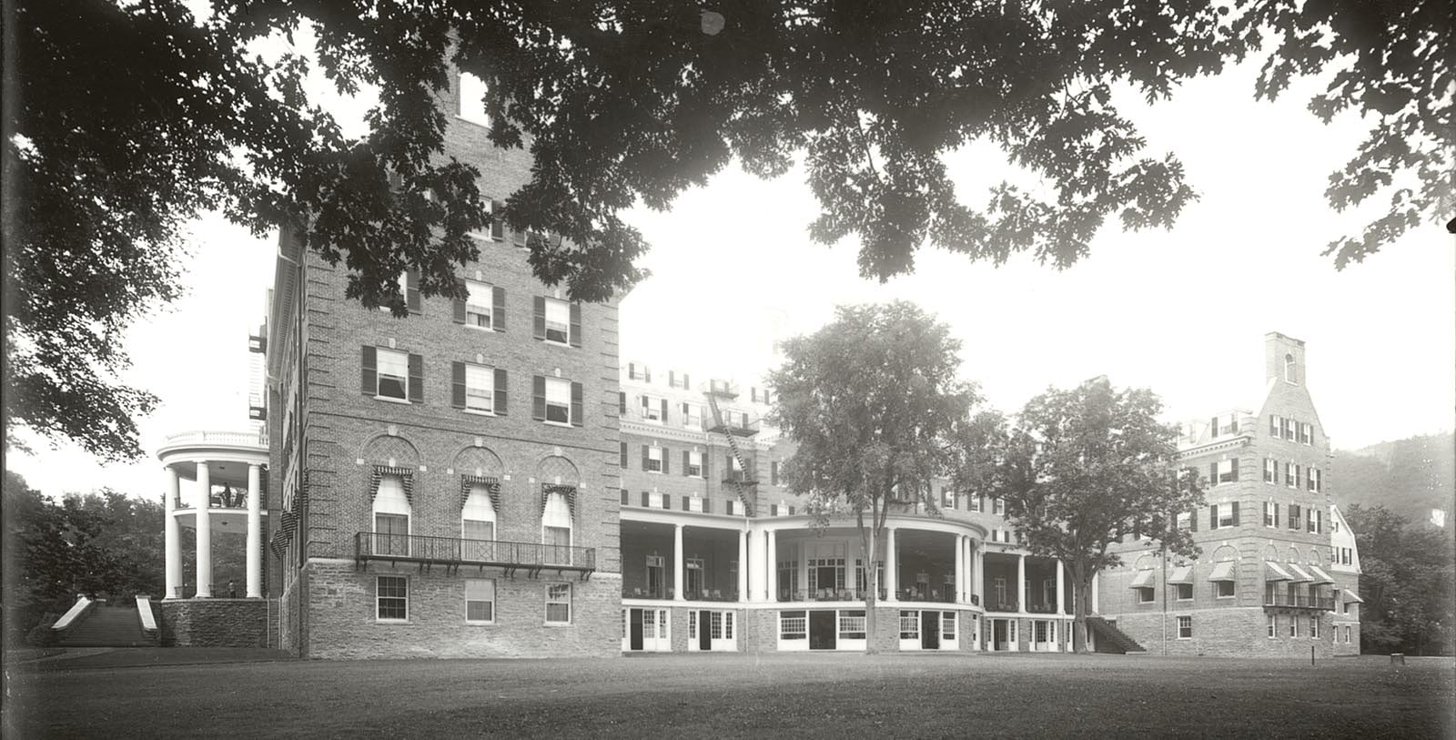 a large brick building with a large porch