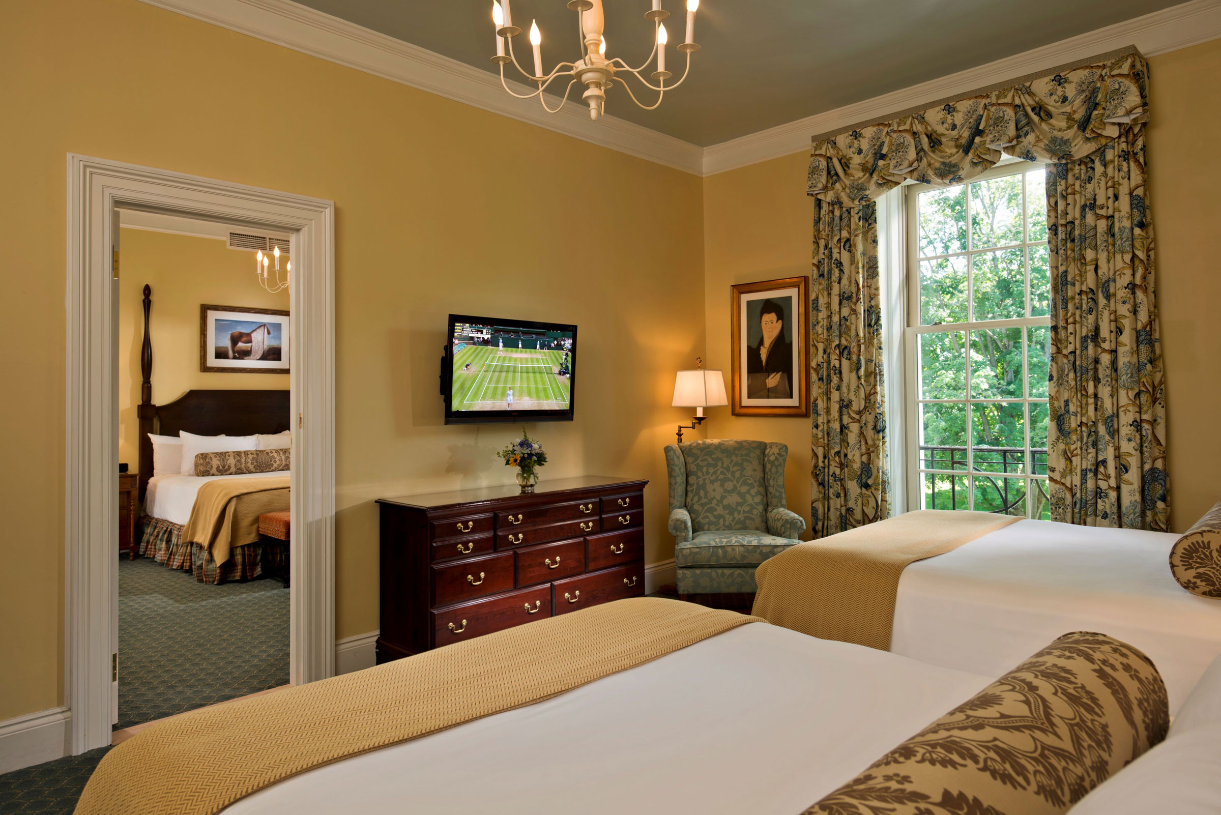 a room with two beds and a television on the wall