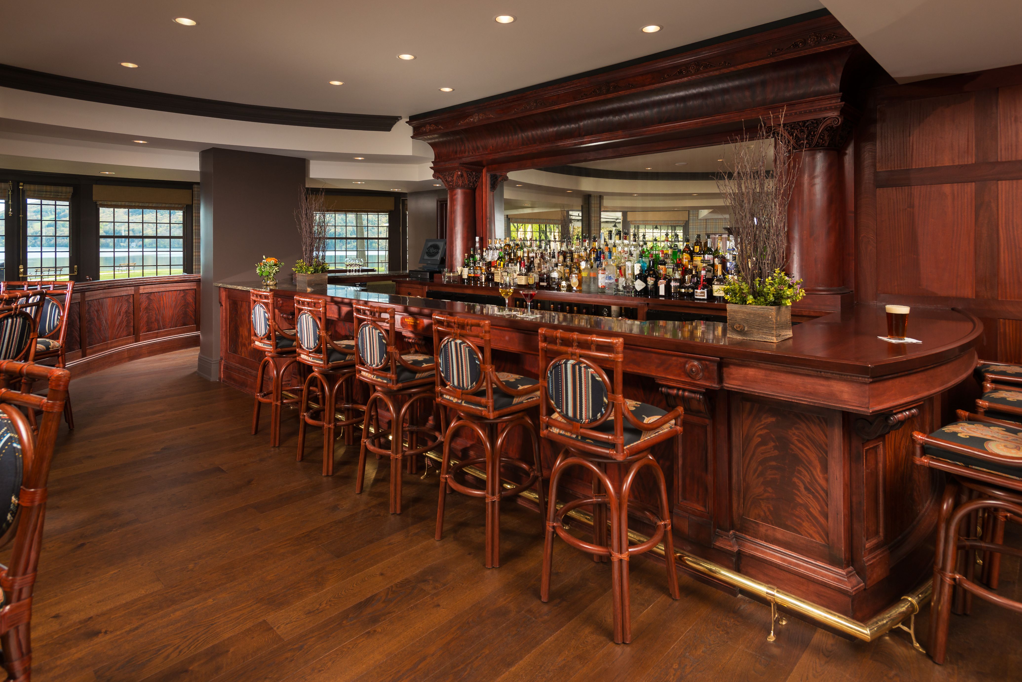 a bar with chairs and a mirror
