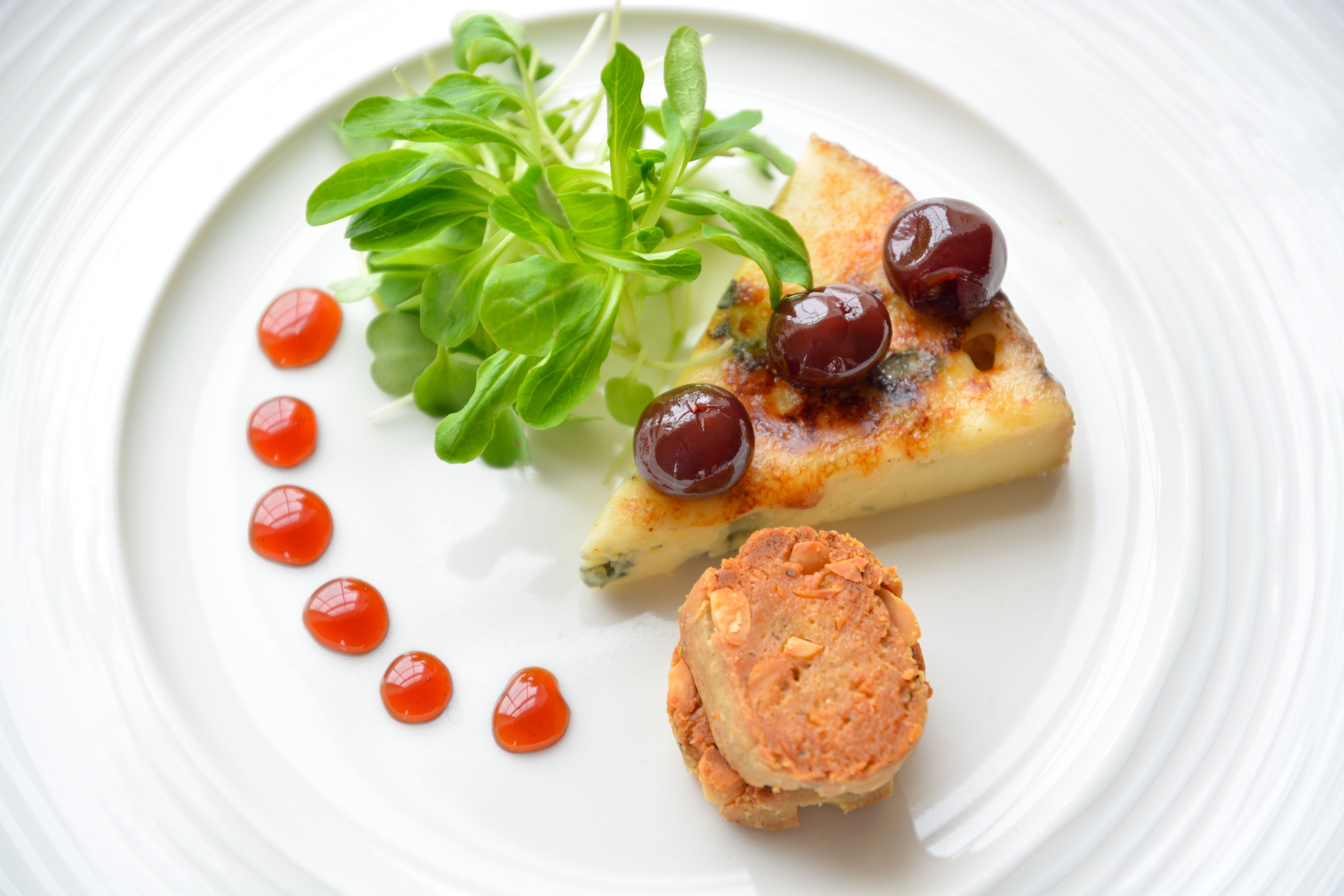 a plate of food with a piece of food and a piece of meat