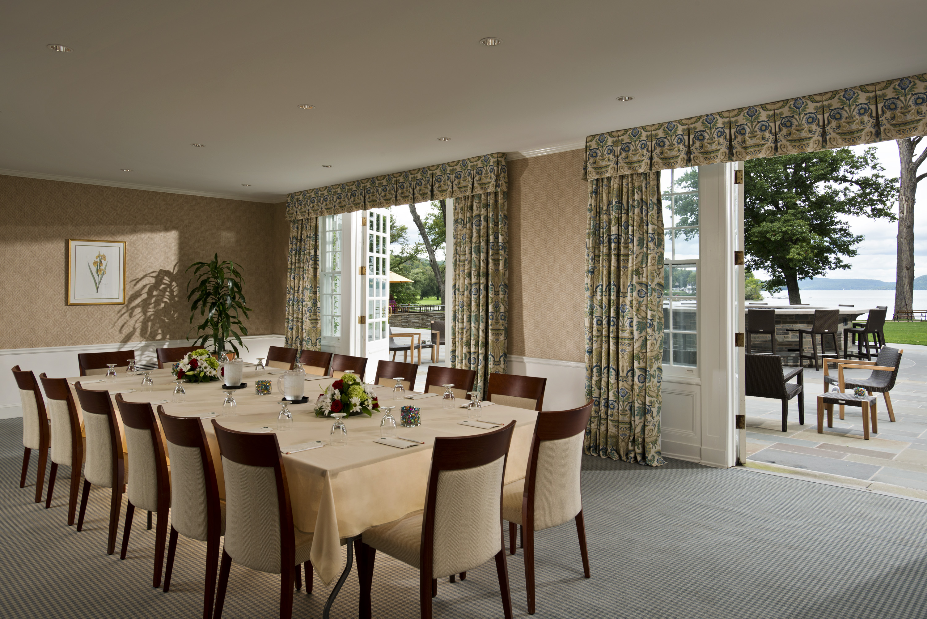 a room with a large table set for a meeting