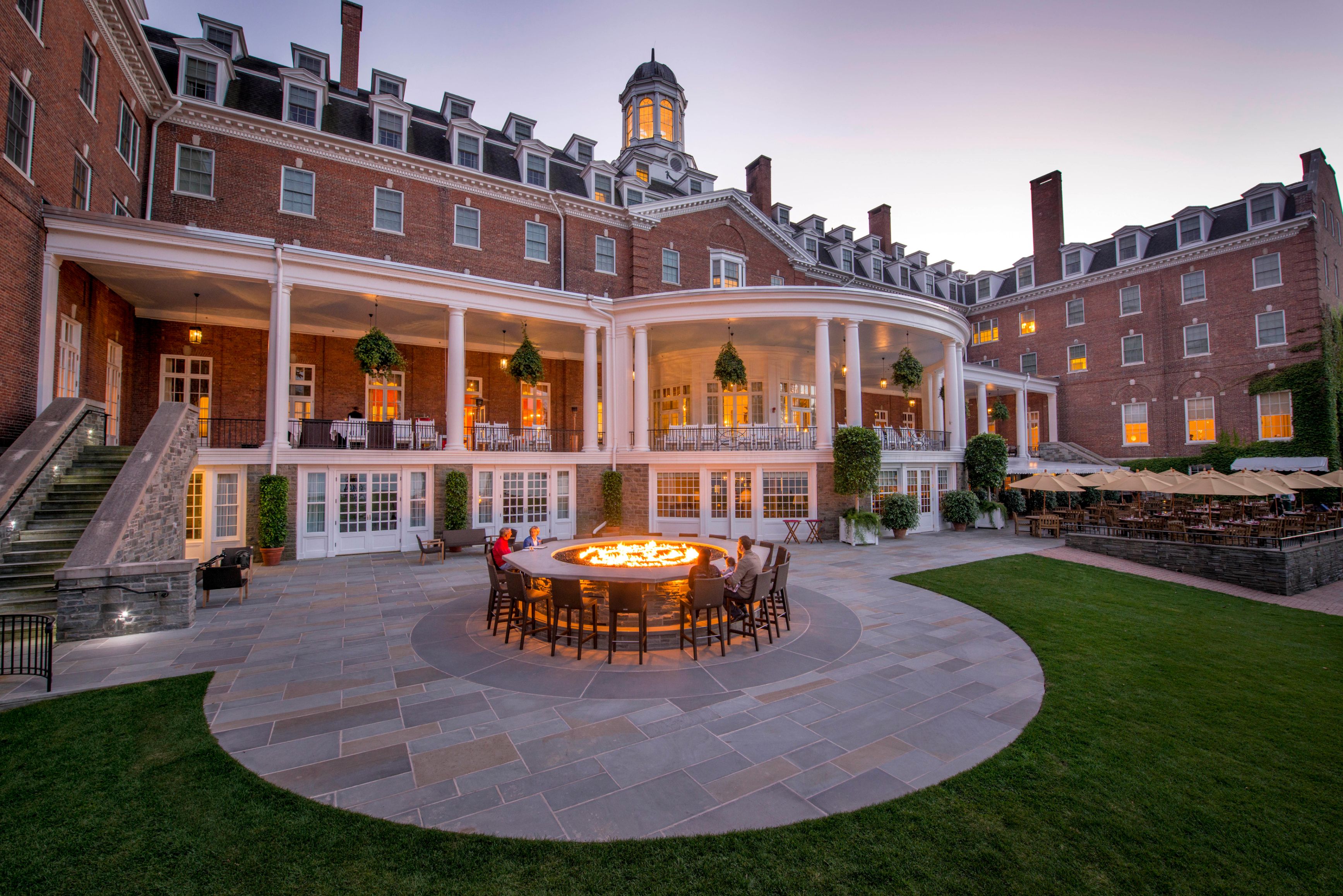 a large brick building with a fire pit in front of it