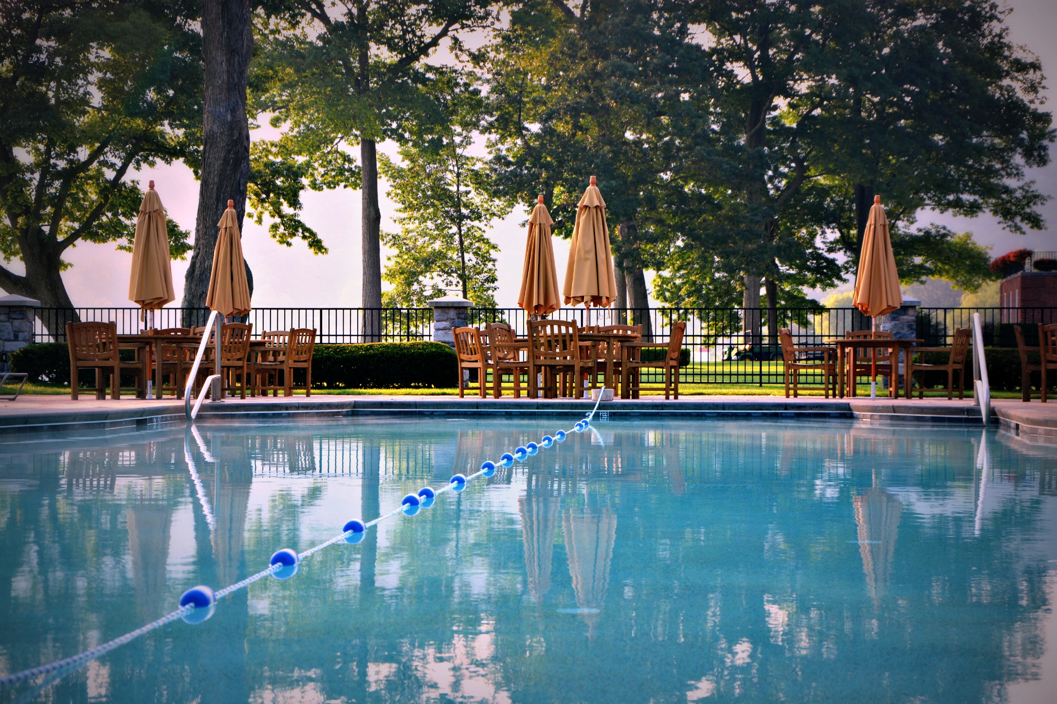 a pool with chairs and umbrellas