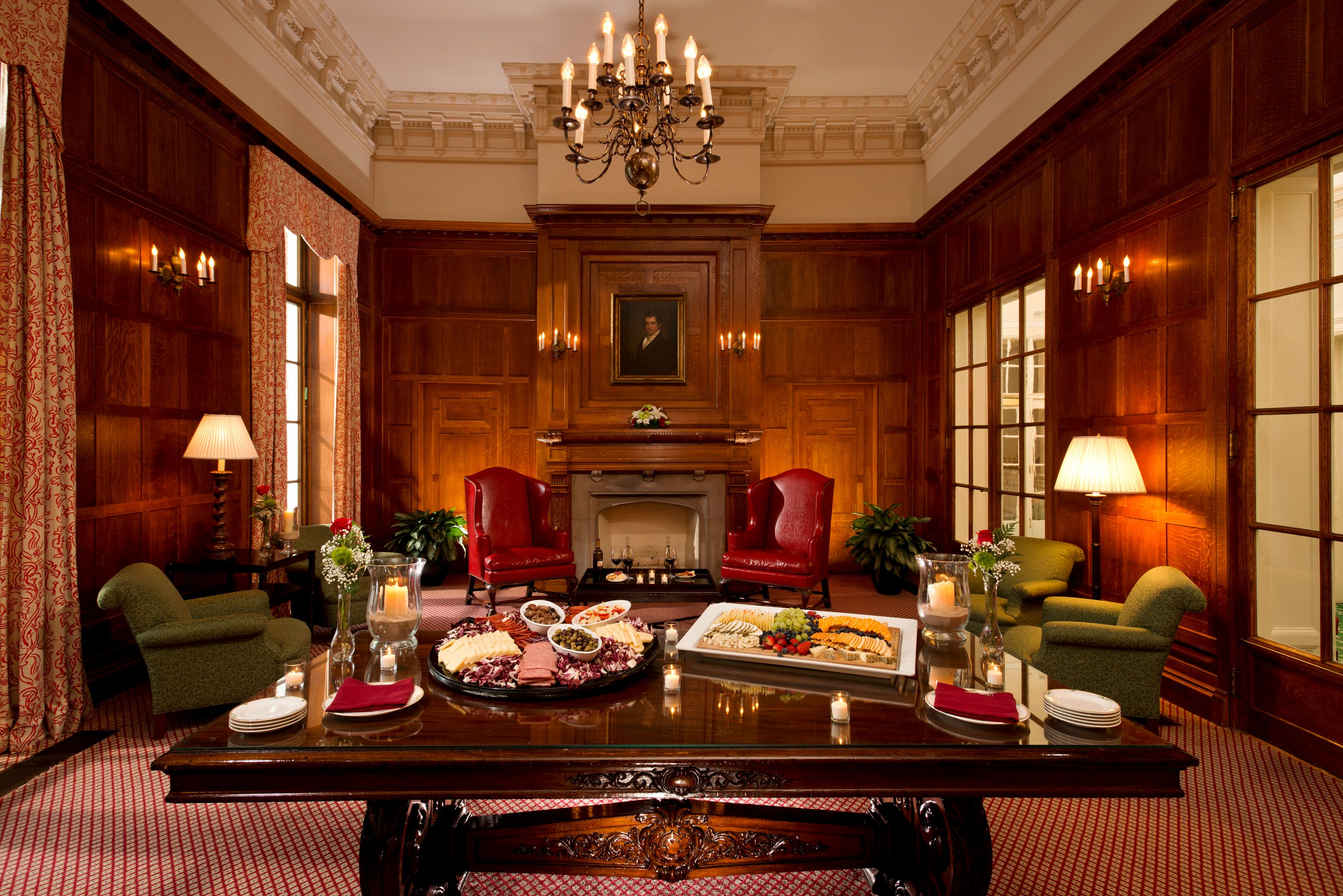 a room with a table of food and a fireplace