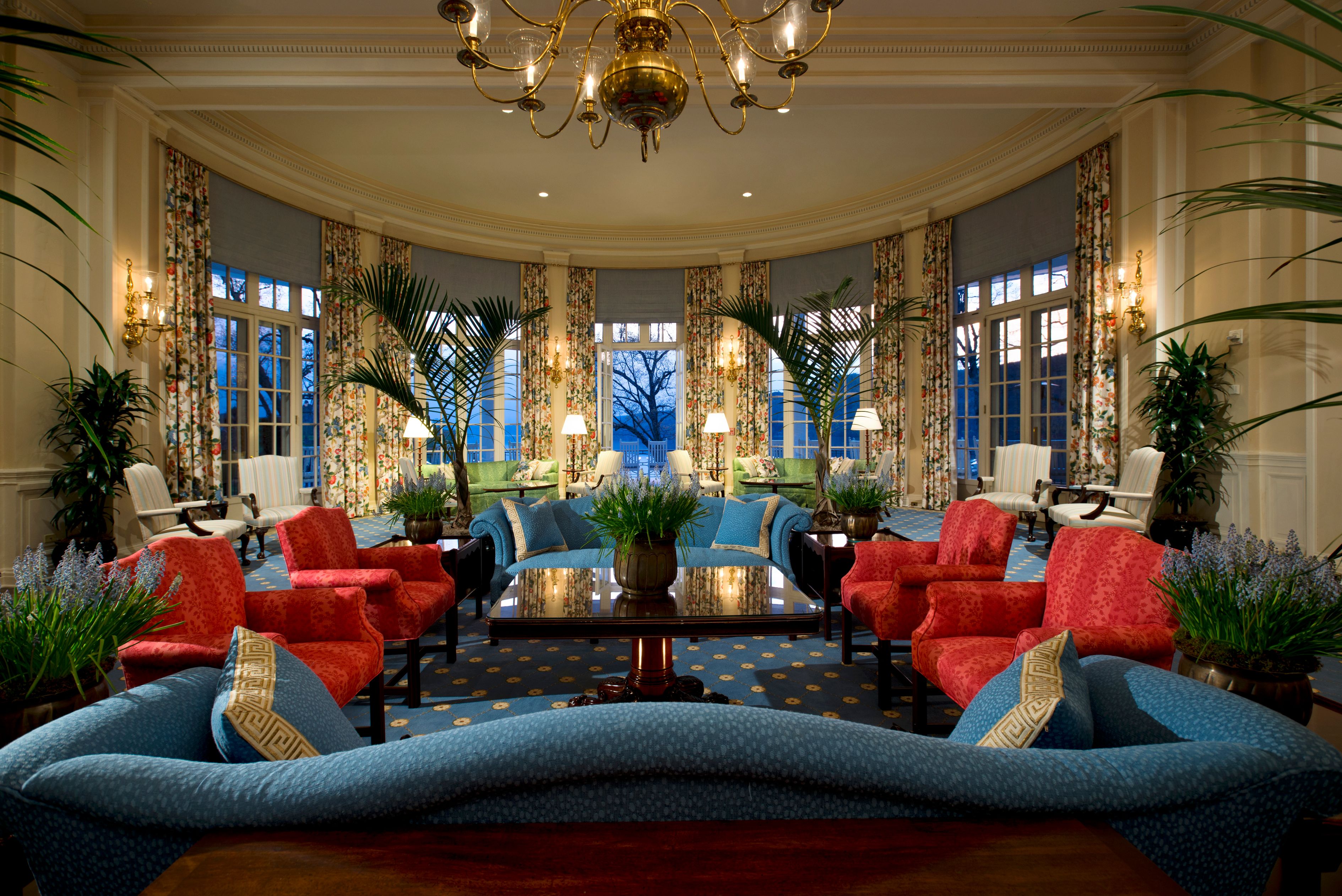 a room with a couch and chairs