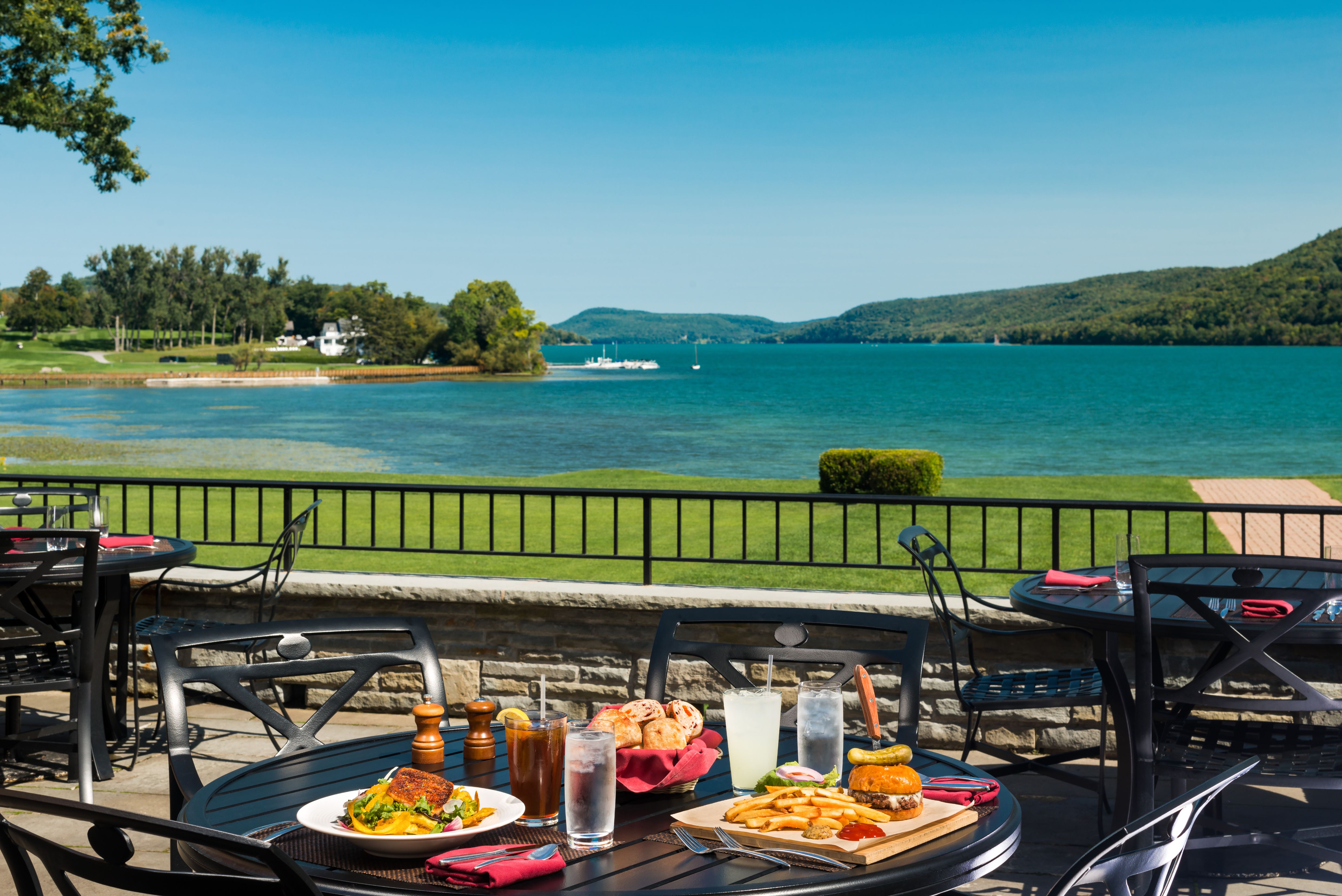 a table with food on it and a body of water in the background