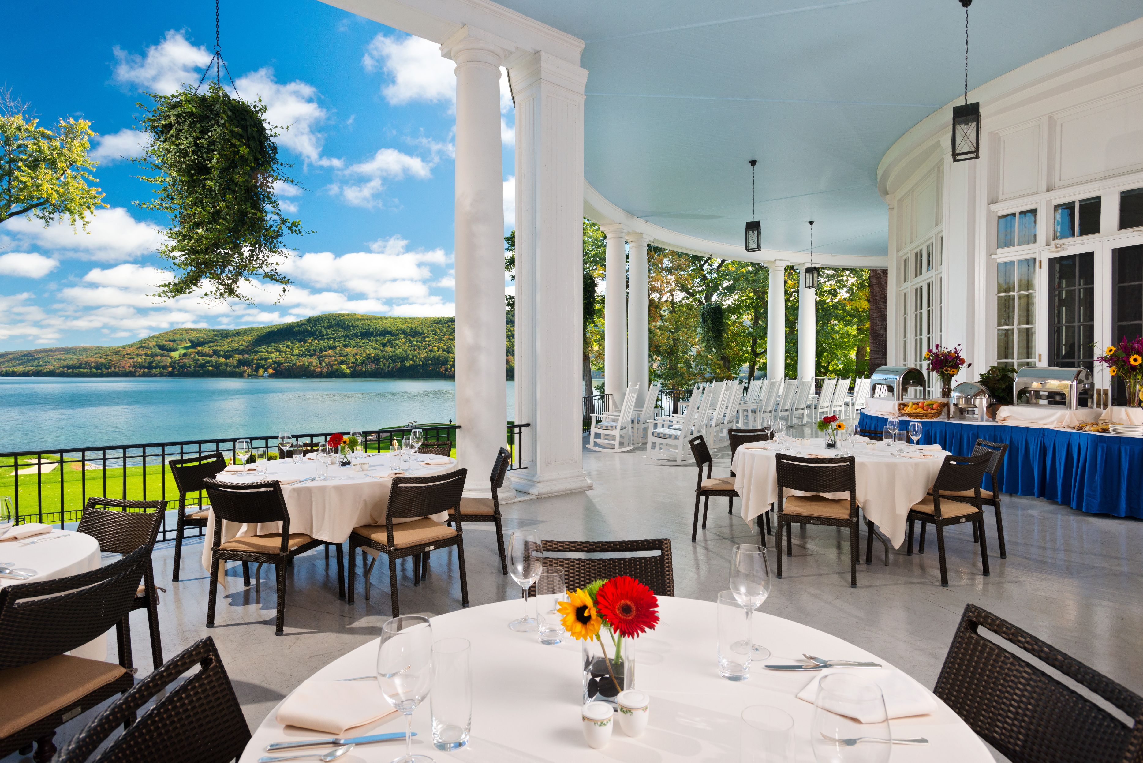 a restaurant with tables and chairs and a lake