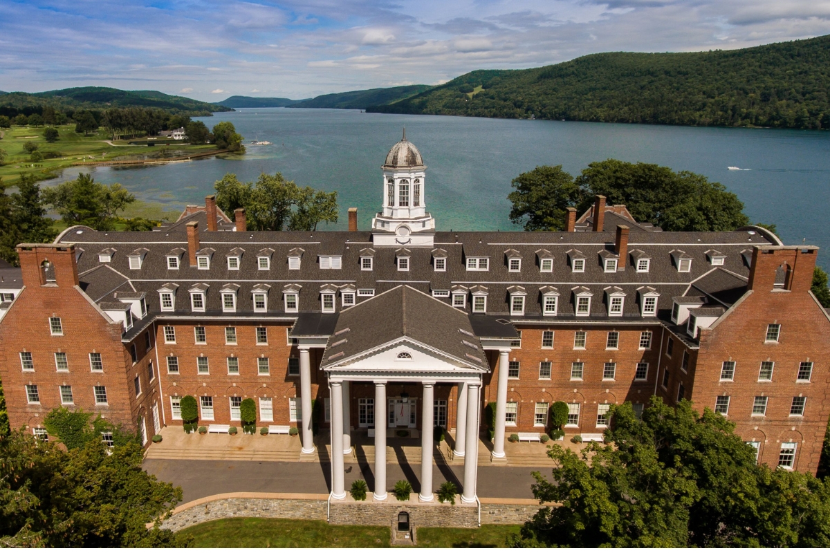 a large building with columns and a body of water