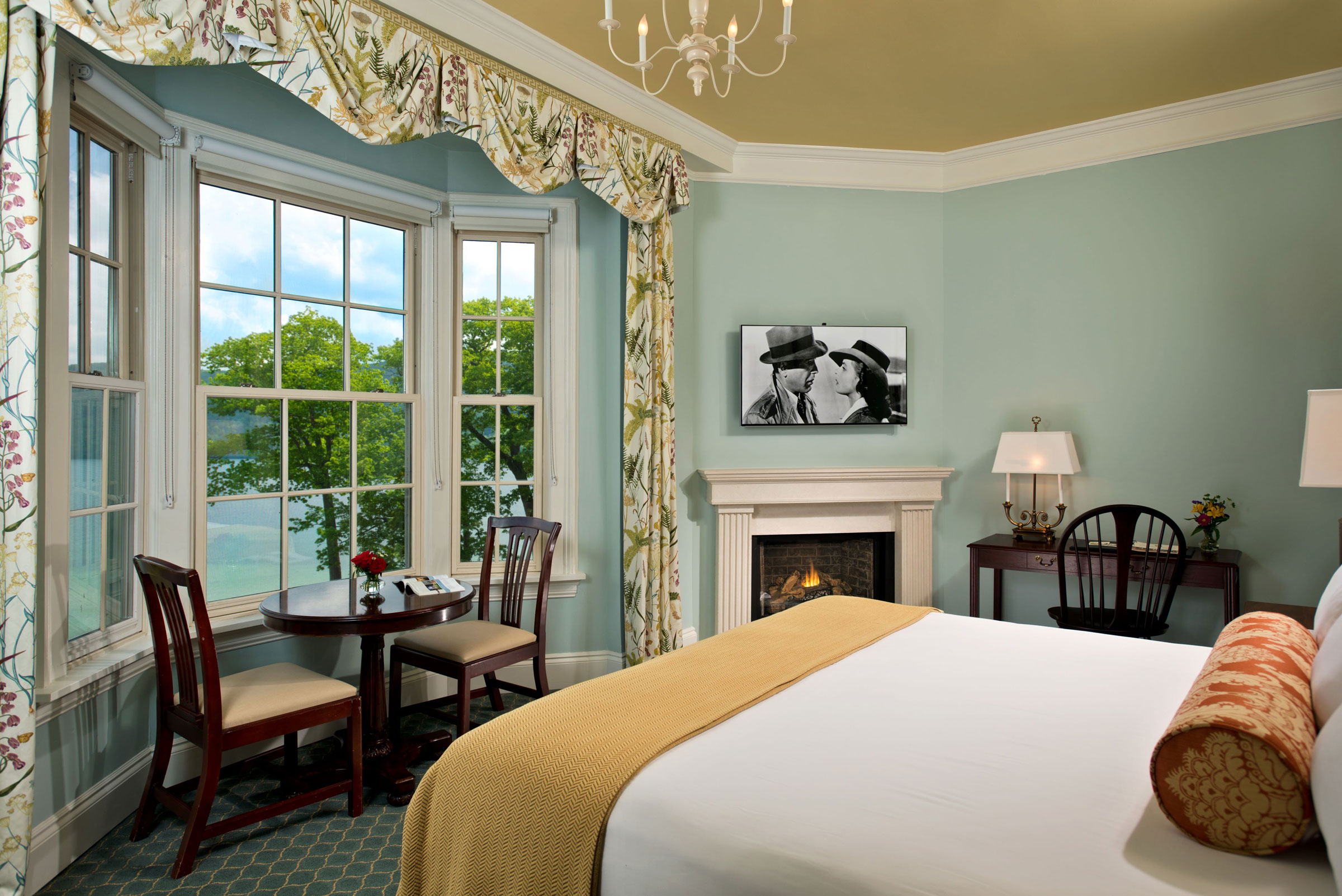 a room with a bed and a fireplace