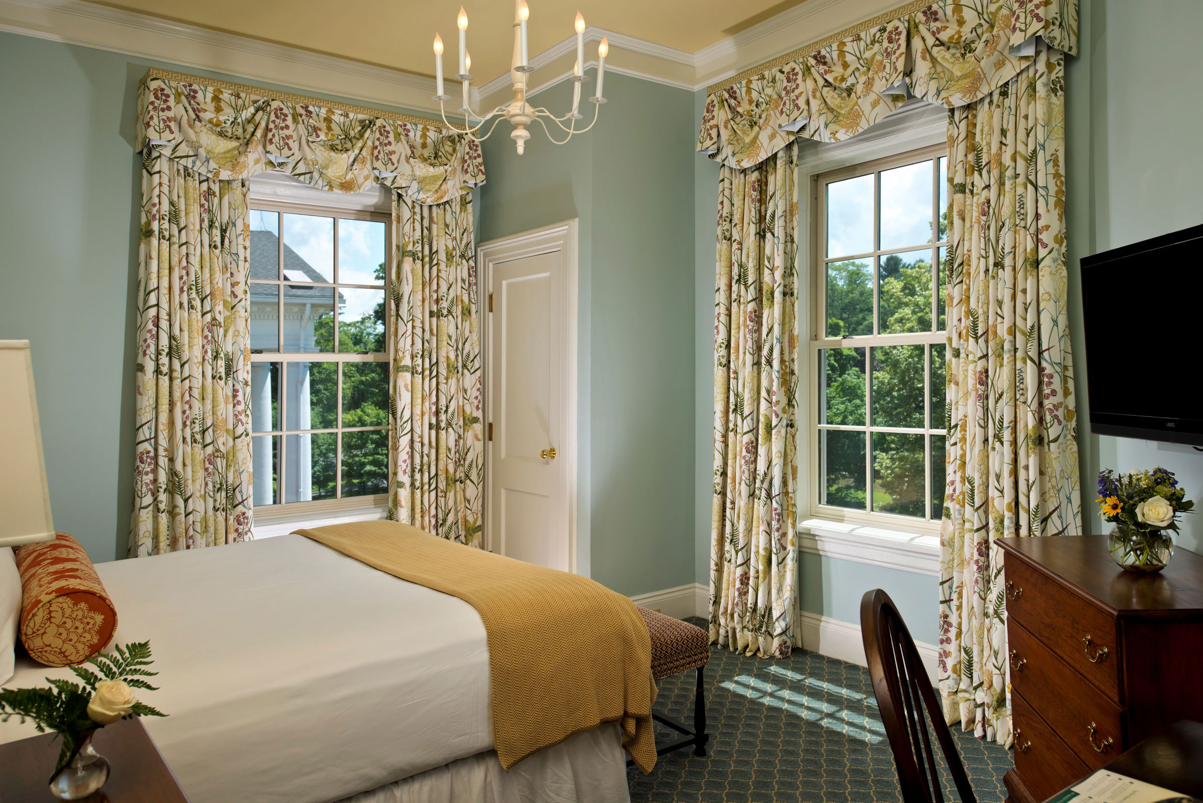 a bedroom with a bed and curtains