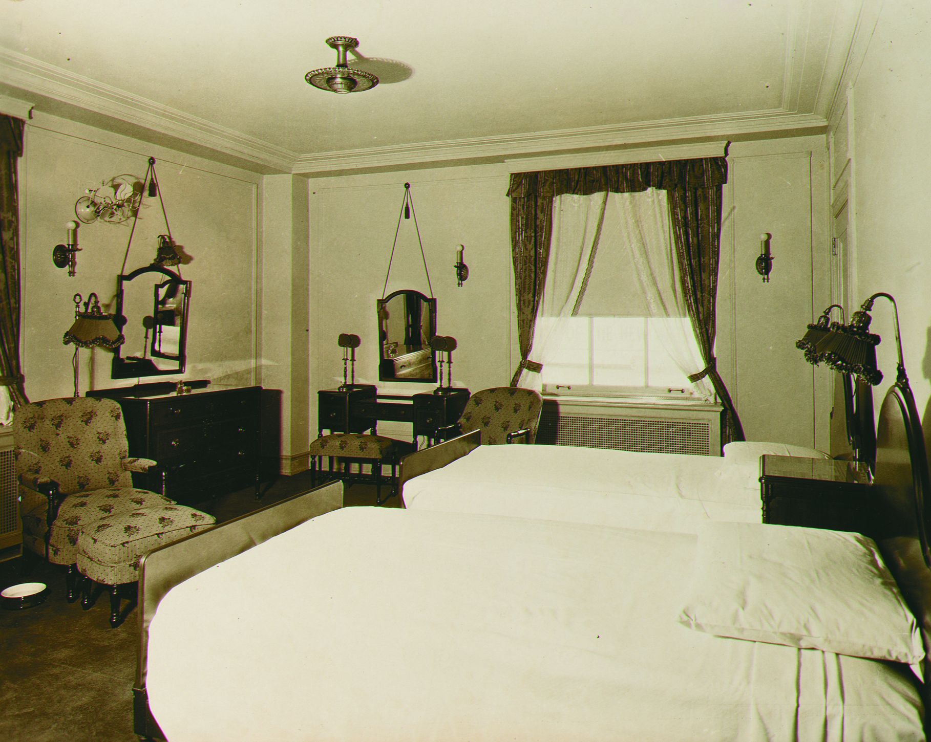a room with two beds and a mirror