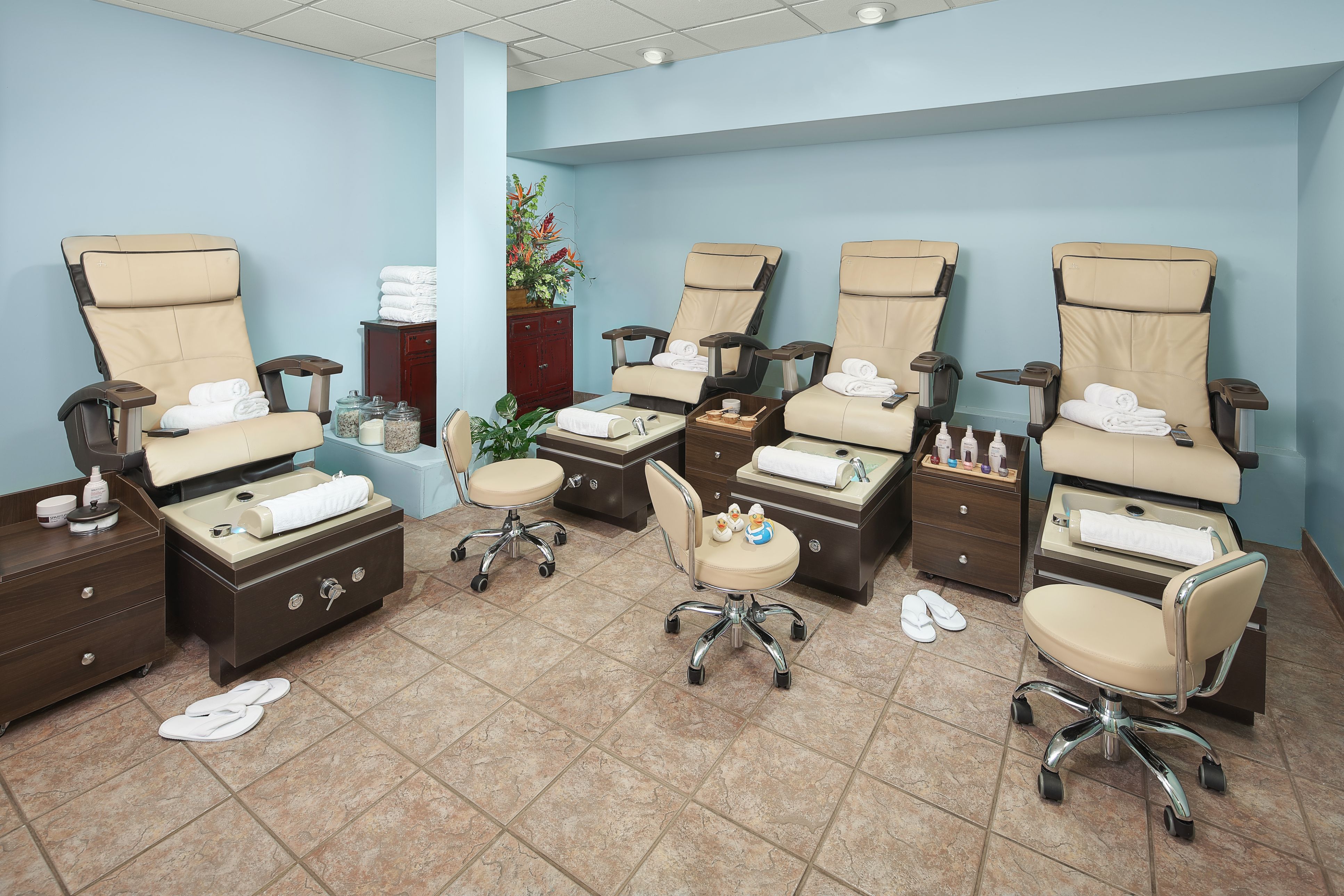 a room with chairs and foot stools