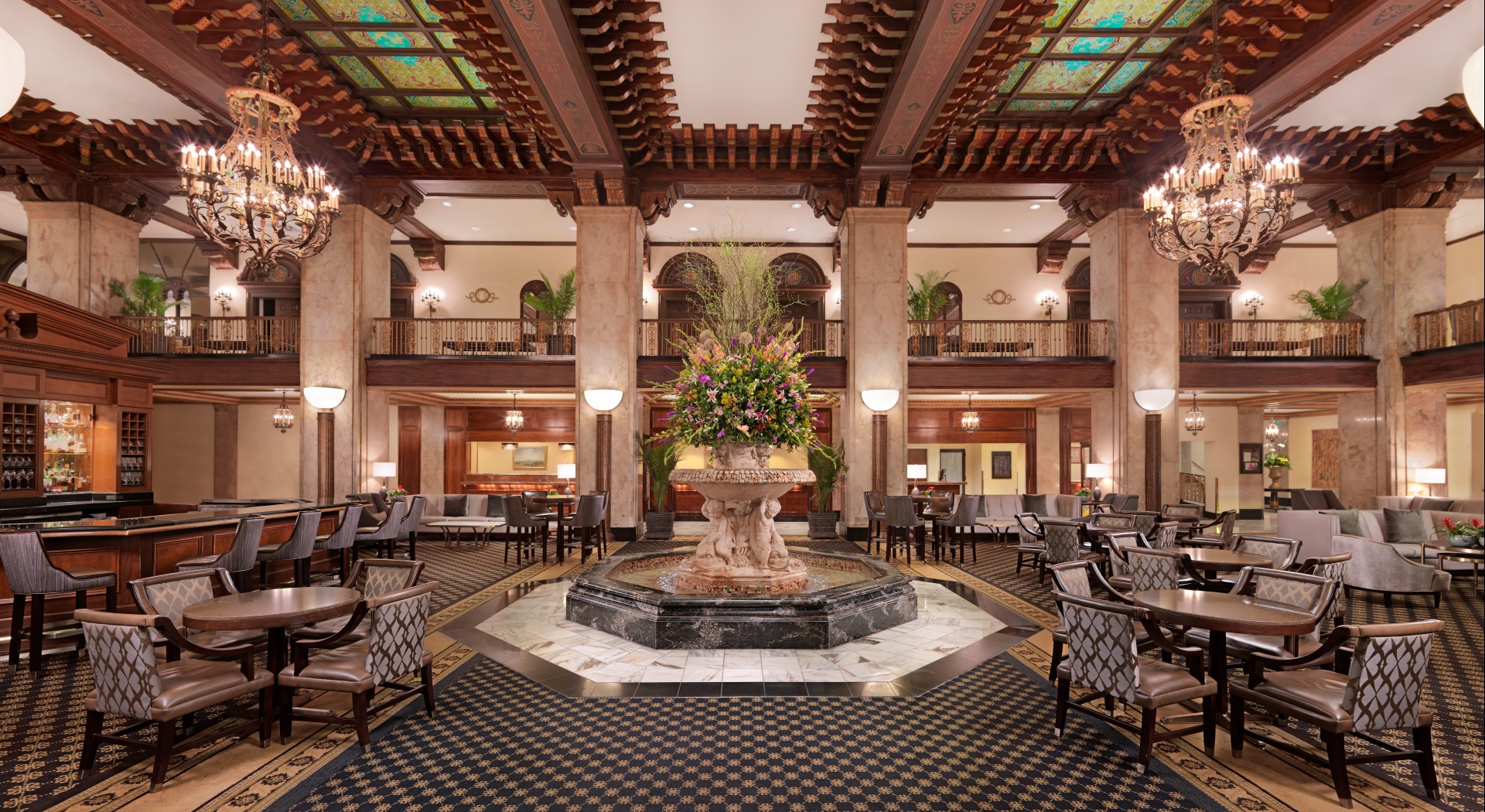 a large room with a fountain and chairs