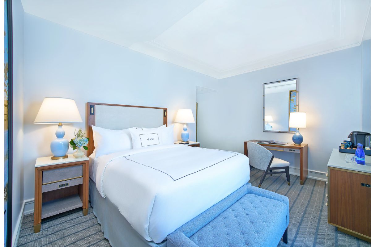 a bedroom with a bed and a chair