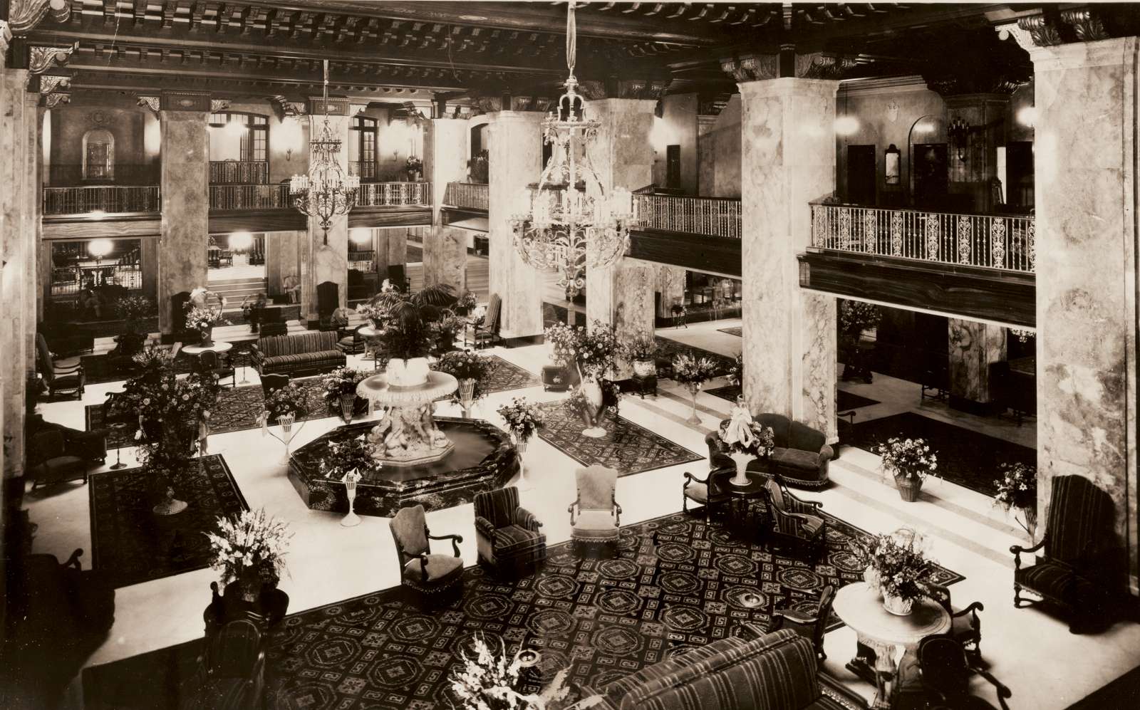 a large room with chandeliers and a fountain