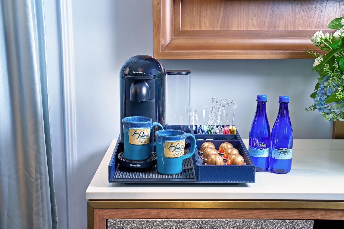 a coffee machine and cups on a tray