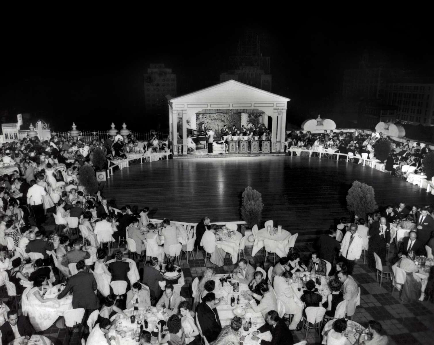 a group of people sitting around a stage