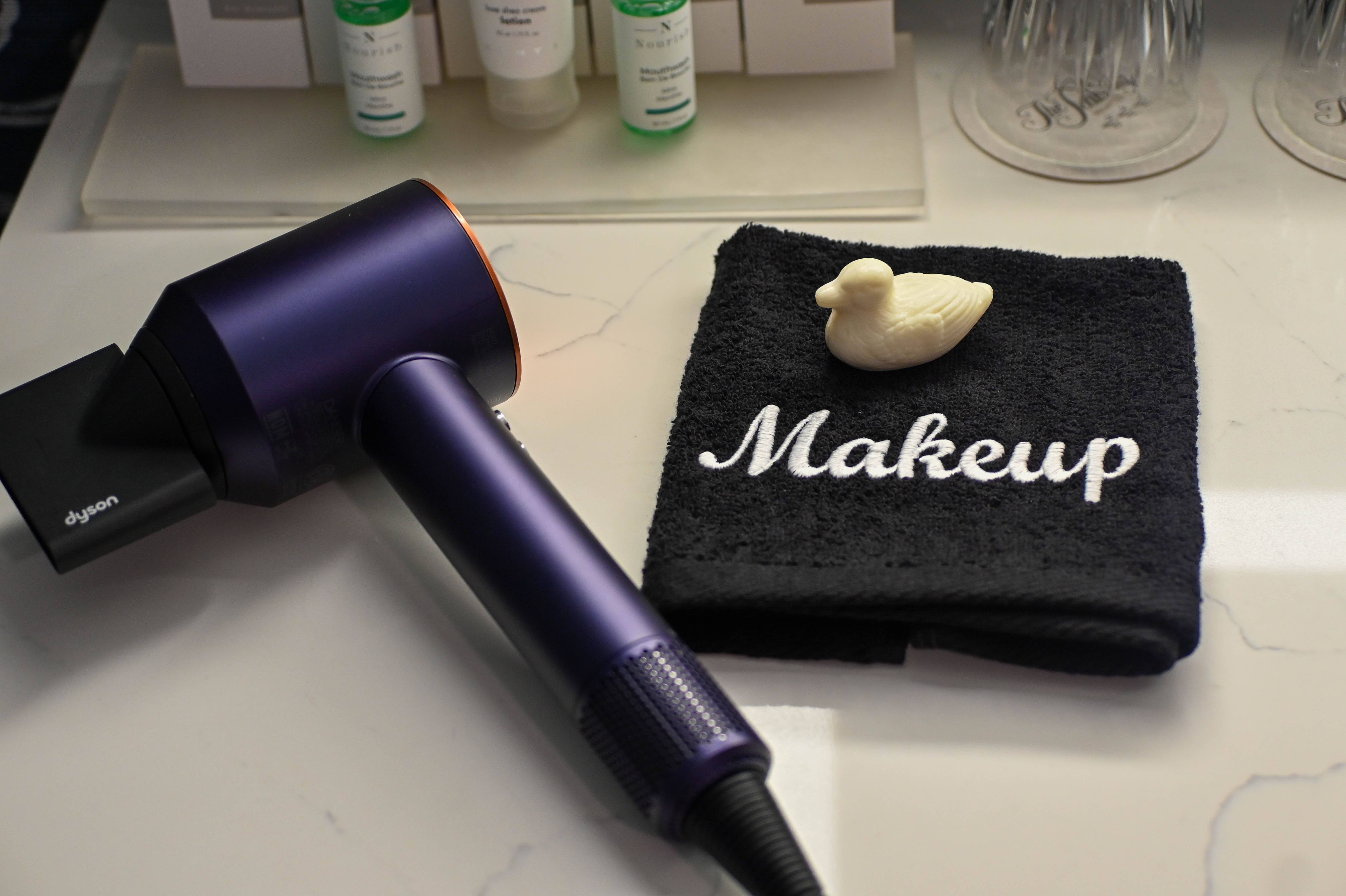 a hair dryer and a towel on a table