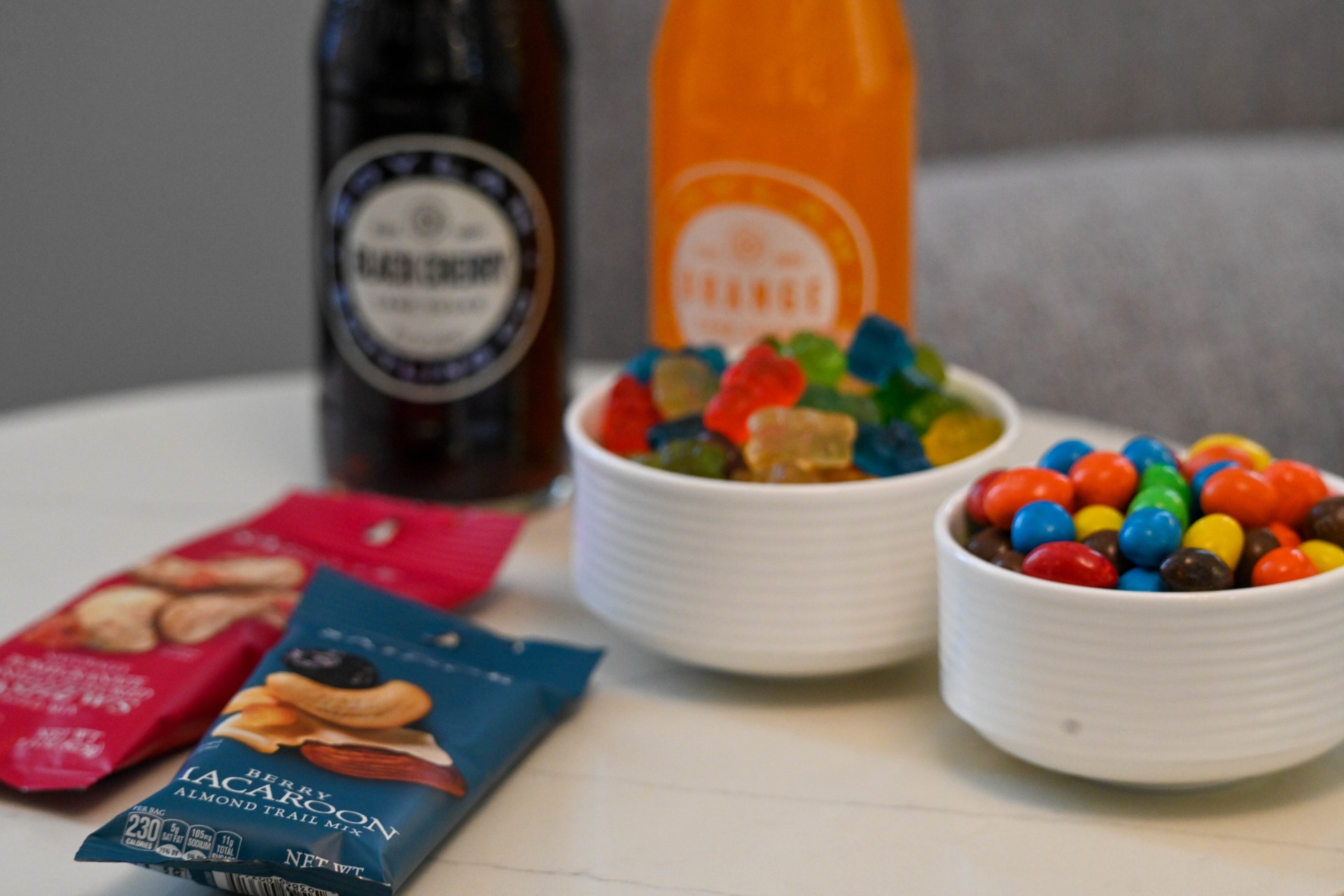 a bowl of candy and a drink
