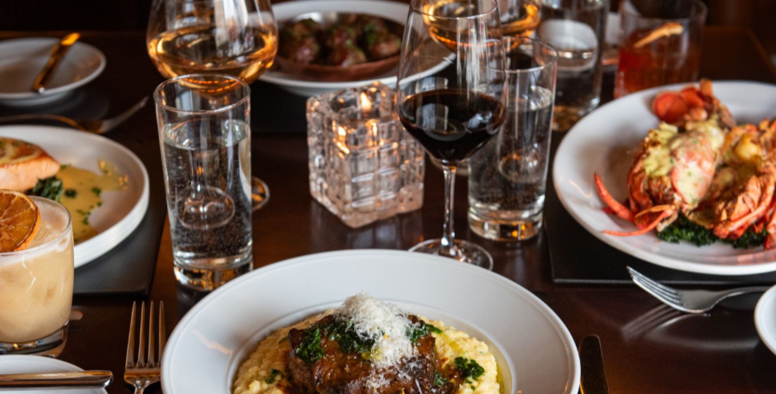 a plate of food and wine glasses on a table