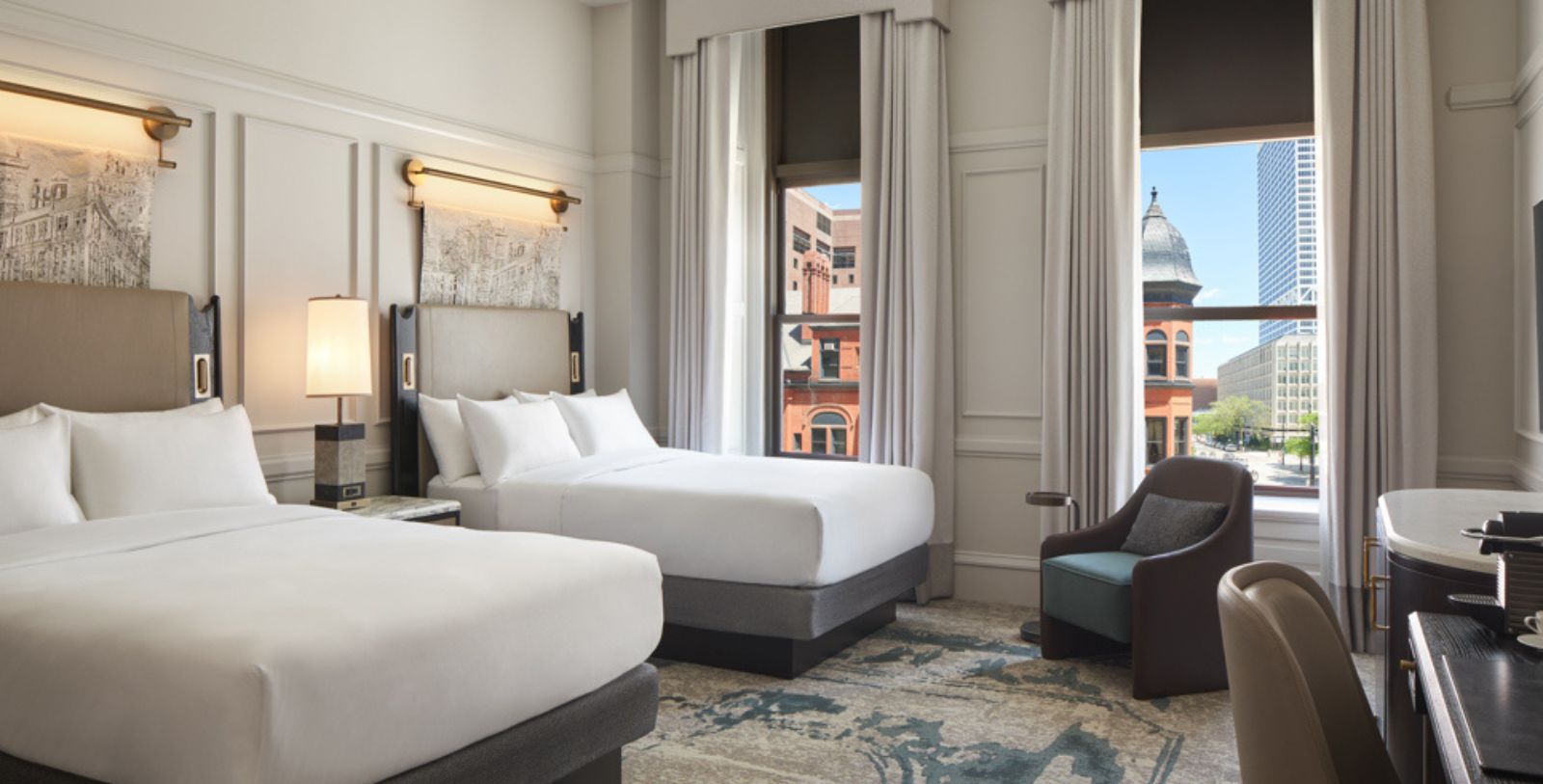 a room with two beds and a chair