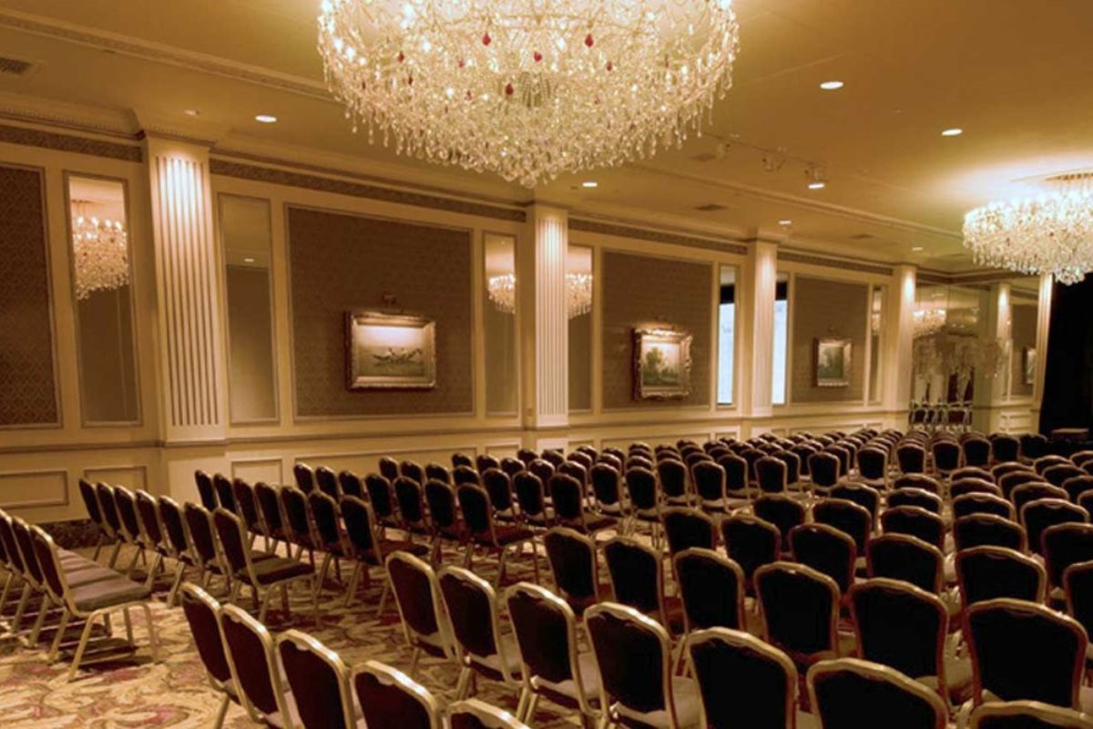 a room with chairs and chandelier