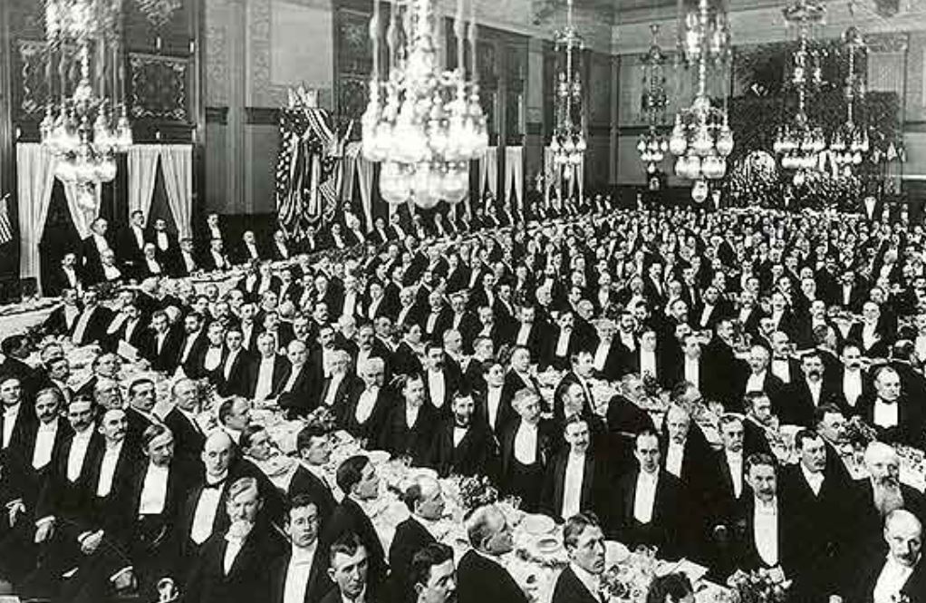 a large group of people sitting at a table