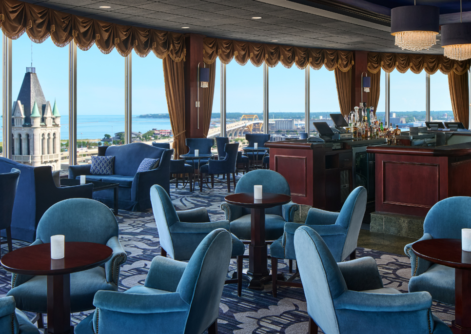 a room with a bar and chairs