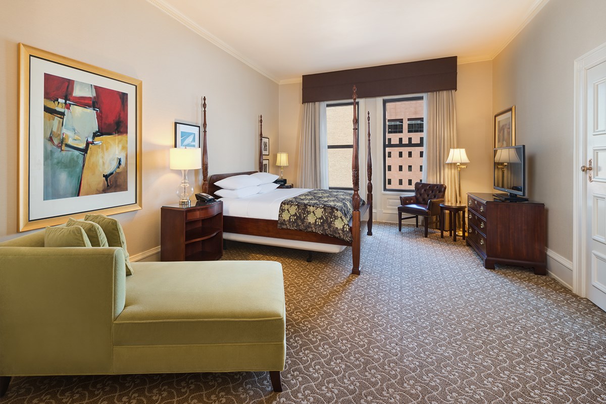 a room with a bed and a television