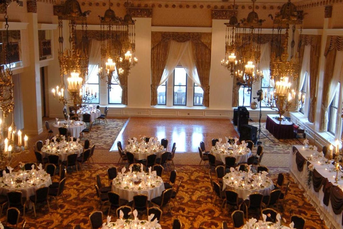 a room with tables and chandeliers